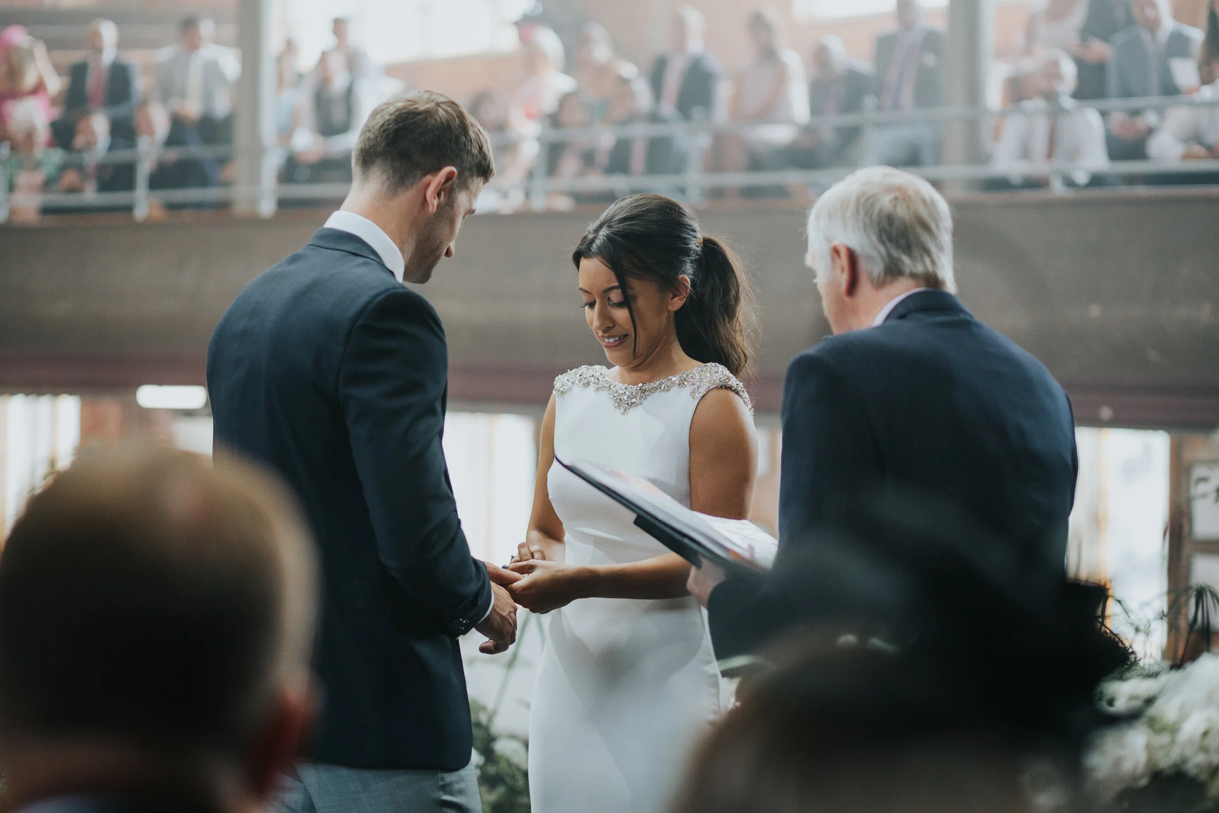 The bride and groom put rings on one and other.