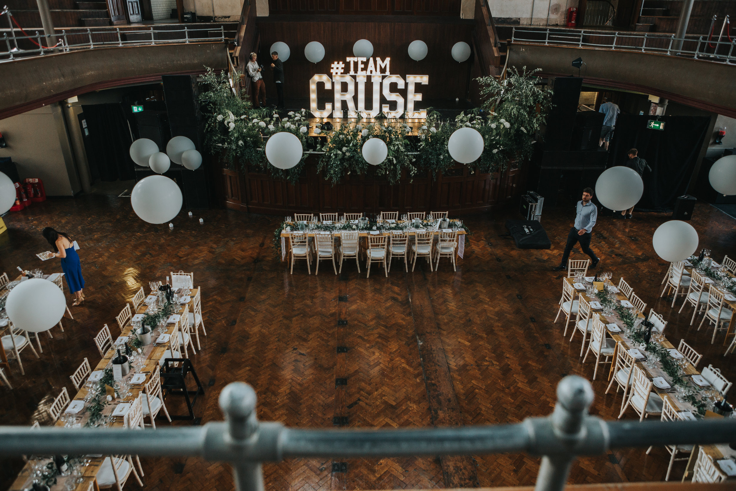 Tables are set up with #TEAMCRUSE sign in the middle. 