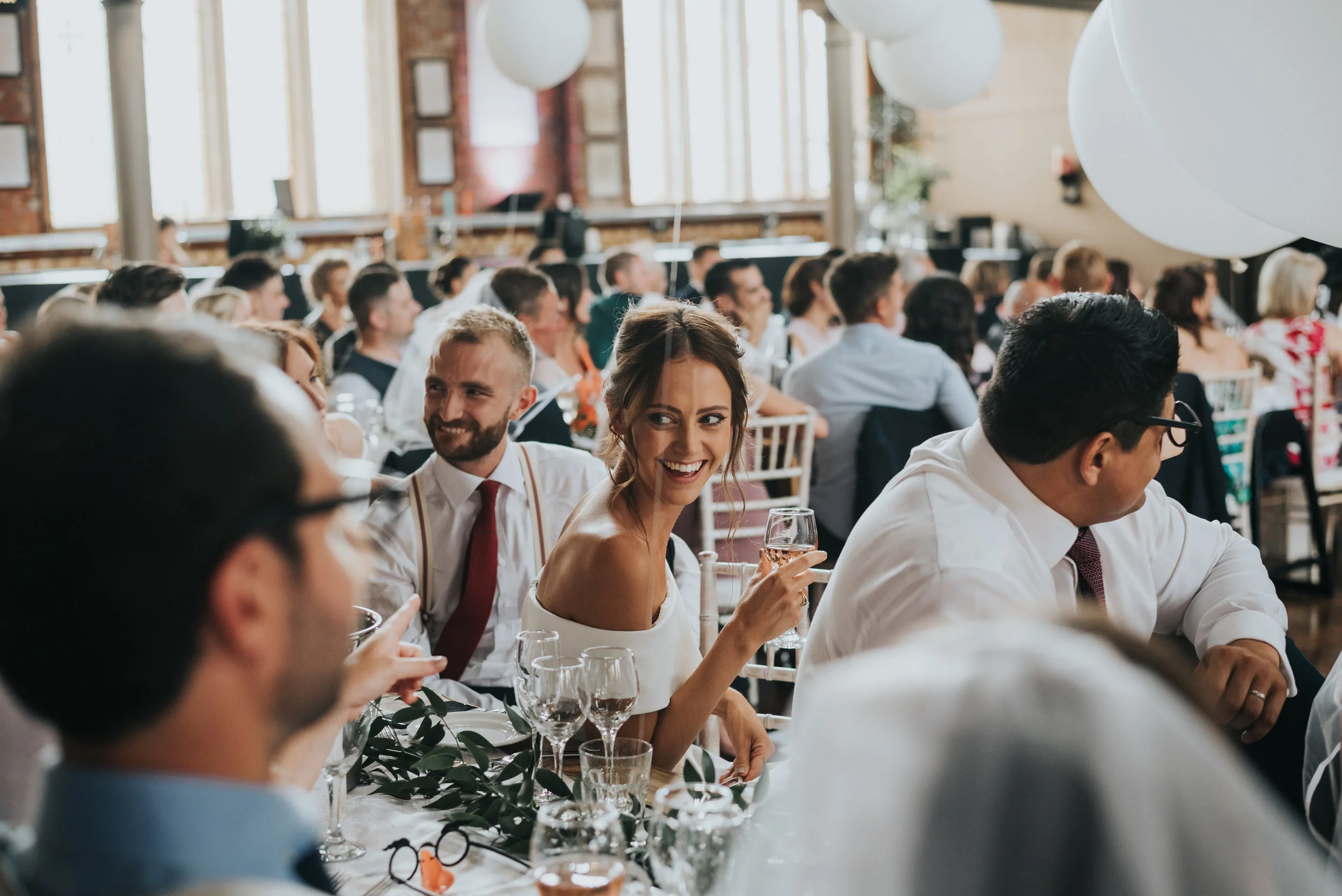Wedding guest smiling in the sunlight.