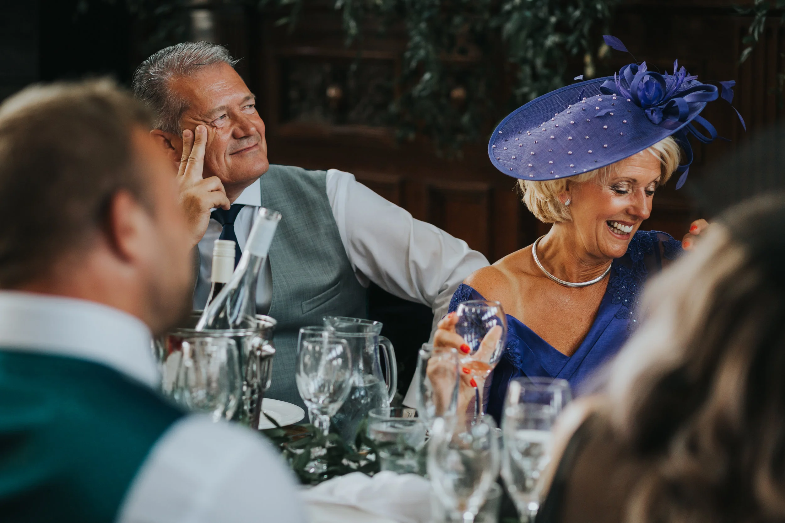Grooms parents smiling.