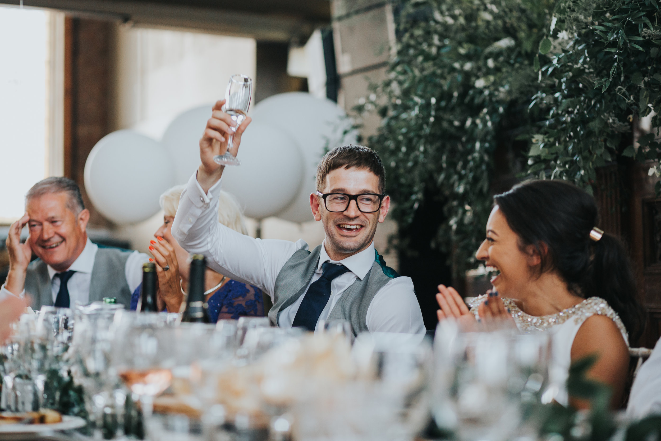 Groom raises a glass to his bride at the end of her speech. 