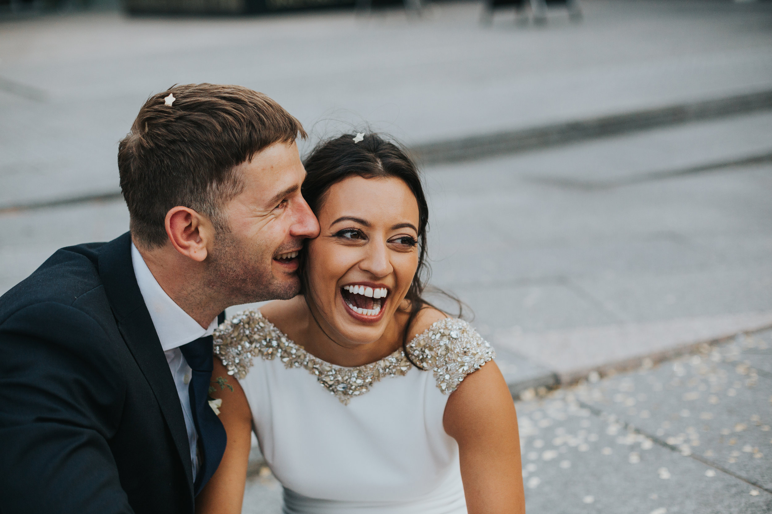 Bride and groom laughing surrounded by glittering stars. 
