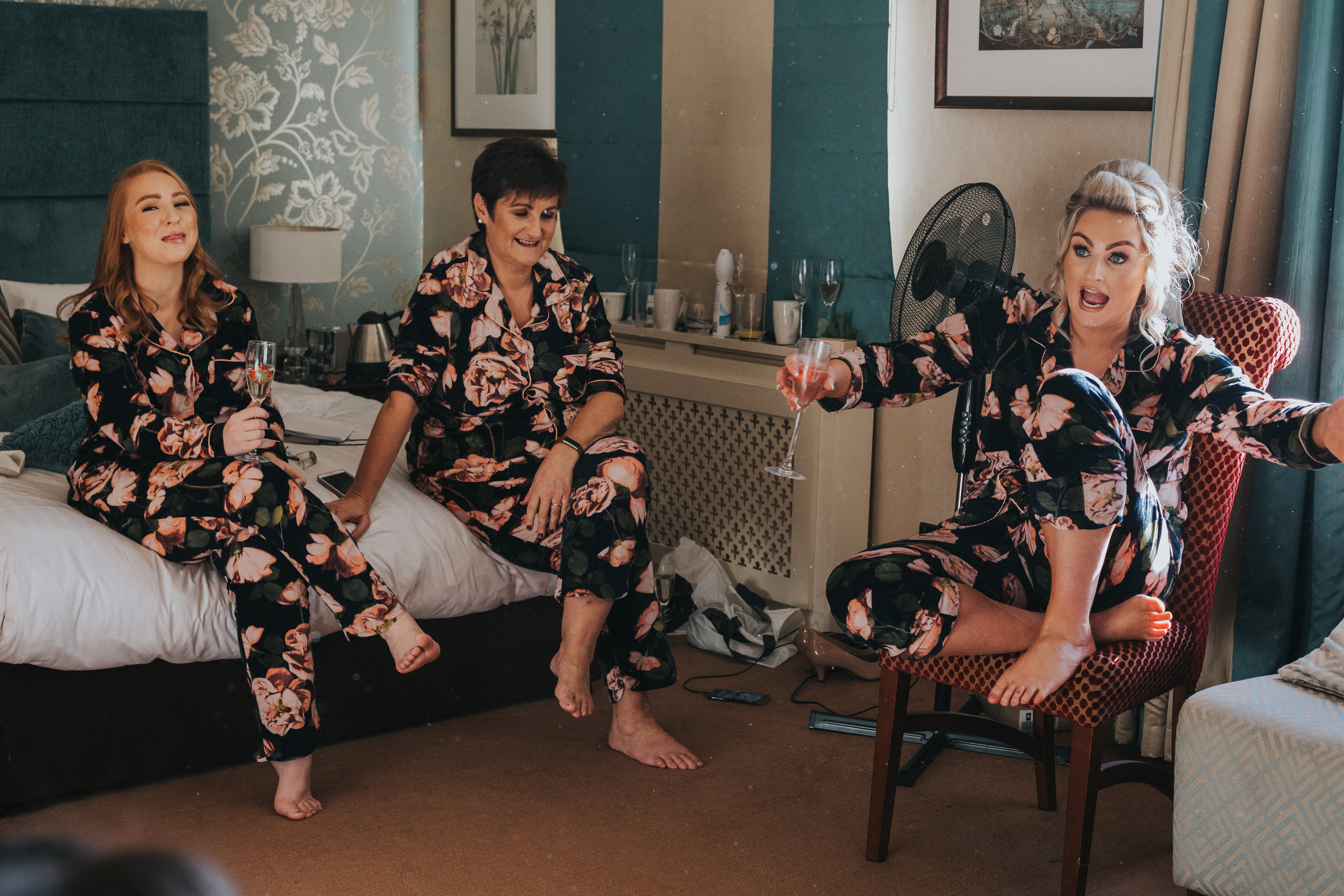 The Bride makes her mother and bridesmaids laugh while telling a story. 