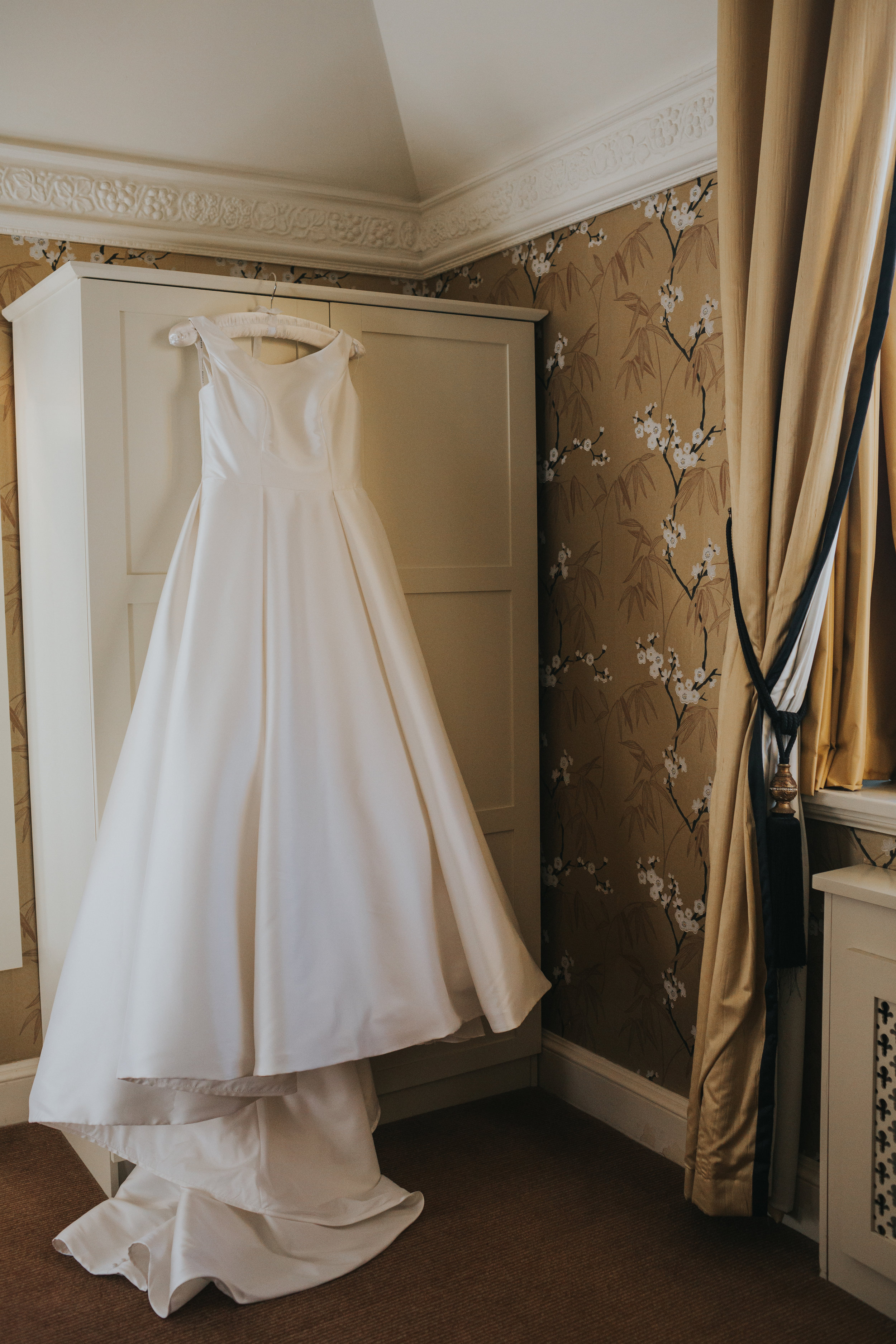 Wedding dress hangs on wardrobe at Inglewood Manor.