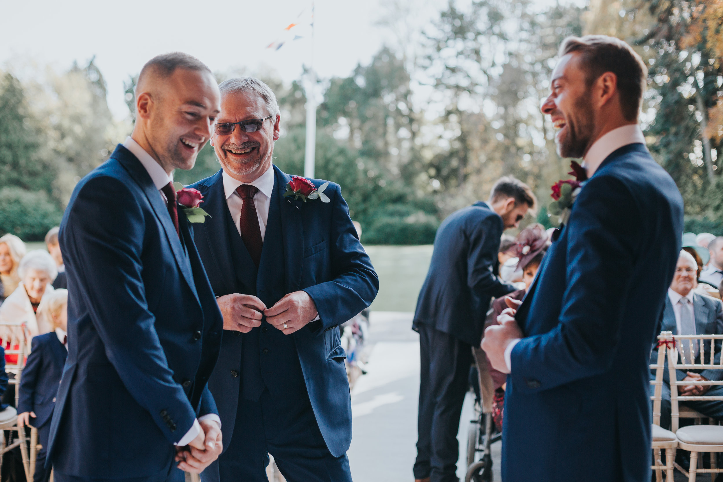 Groomsmen laugh together in the the sunlight at Inglewood Manor. 