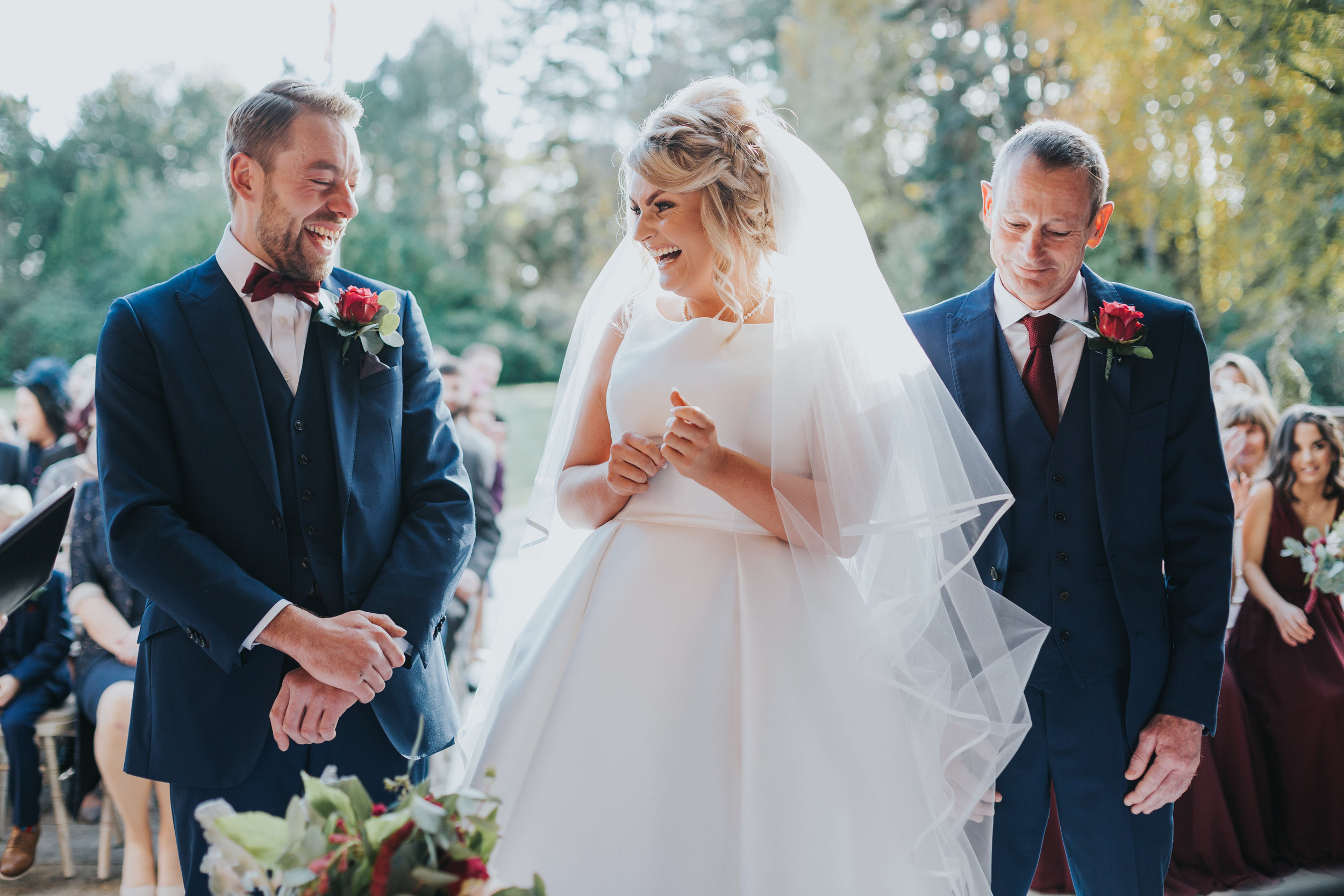 The bride and groom look at one and other, beaming from ear to ear at their outdoor ceremony at Inglewood Manor. 