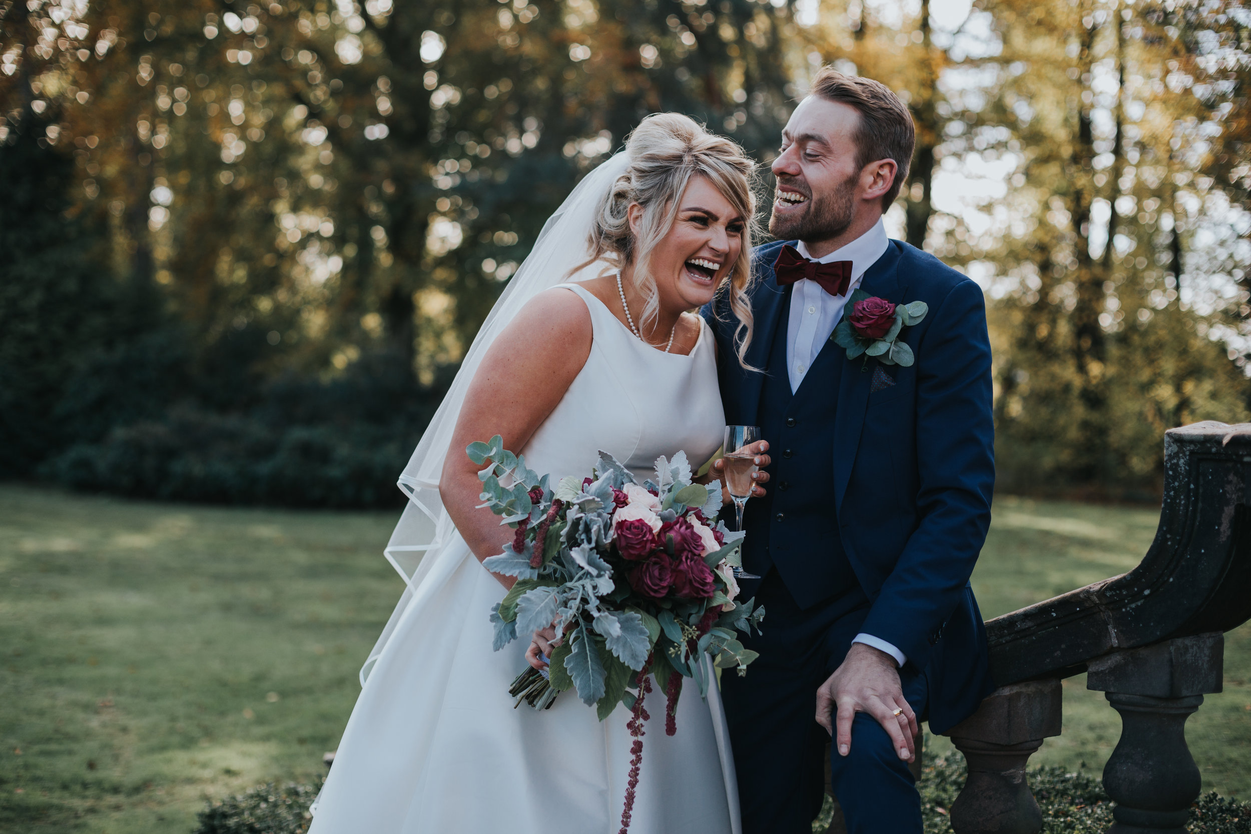 Couple laugh together during their Autumnal wedding at Inglewood Manor. 