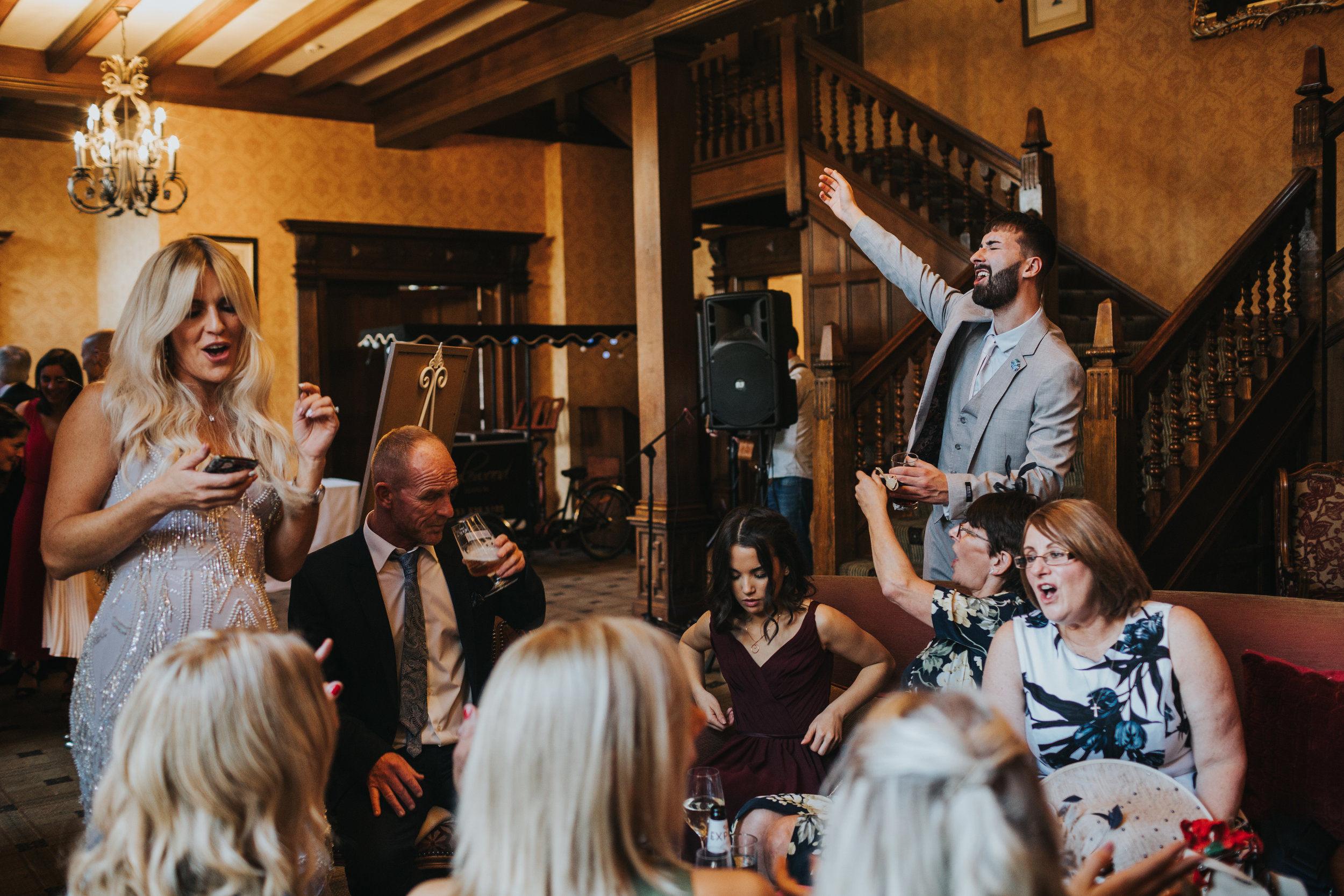 Wedding guests sing together.
