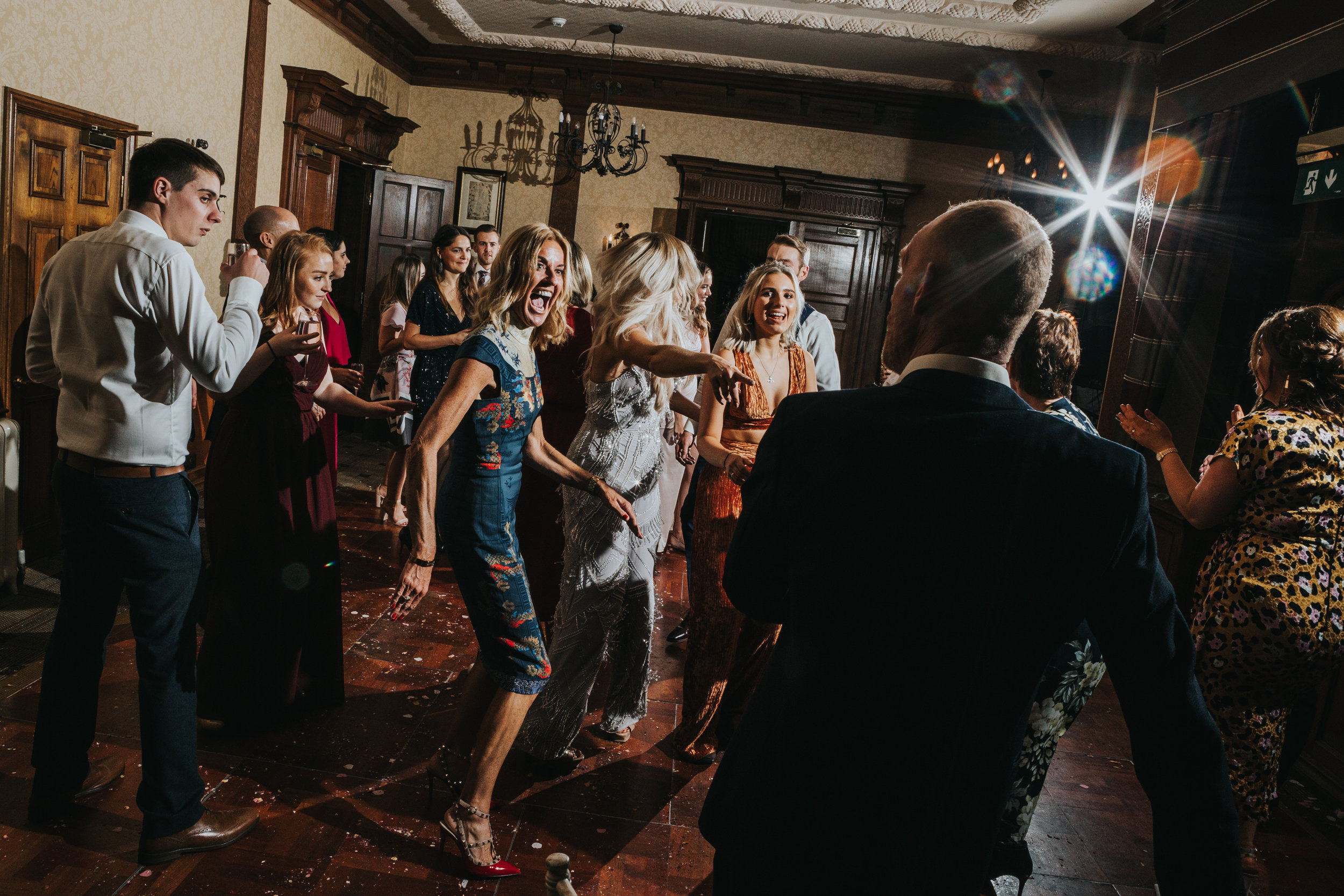 Wedding guest dances making an excited face at her partner. 