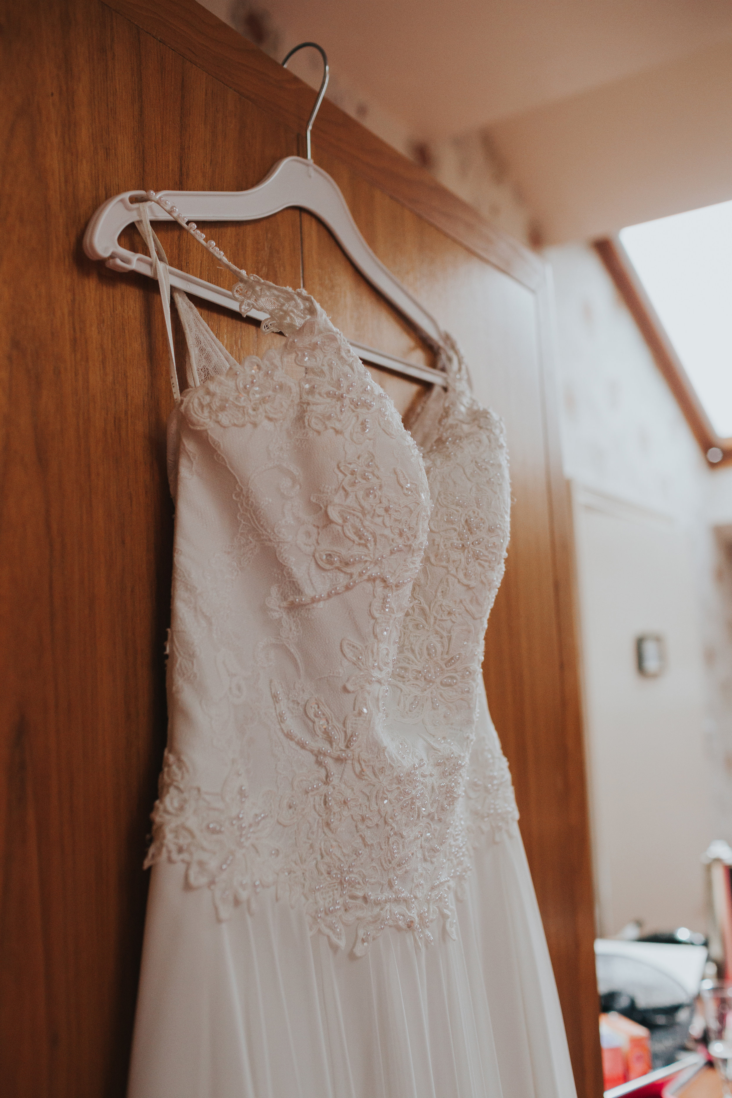 Wedding dress hanging on wardrobe. 