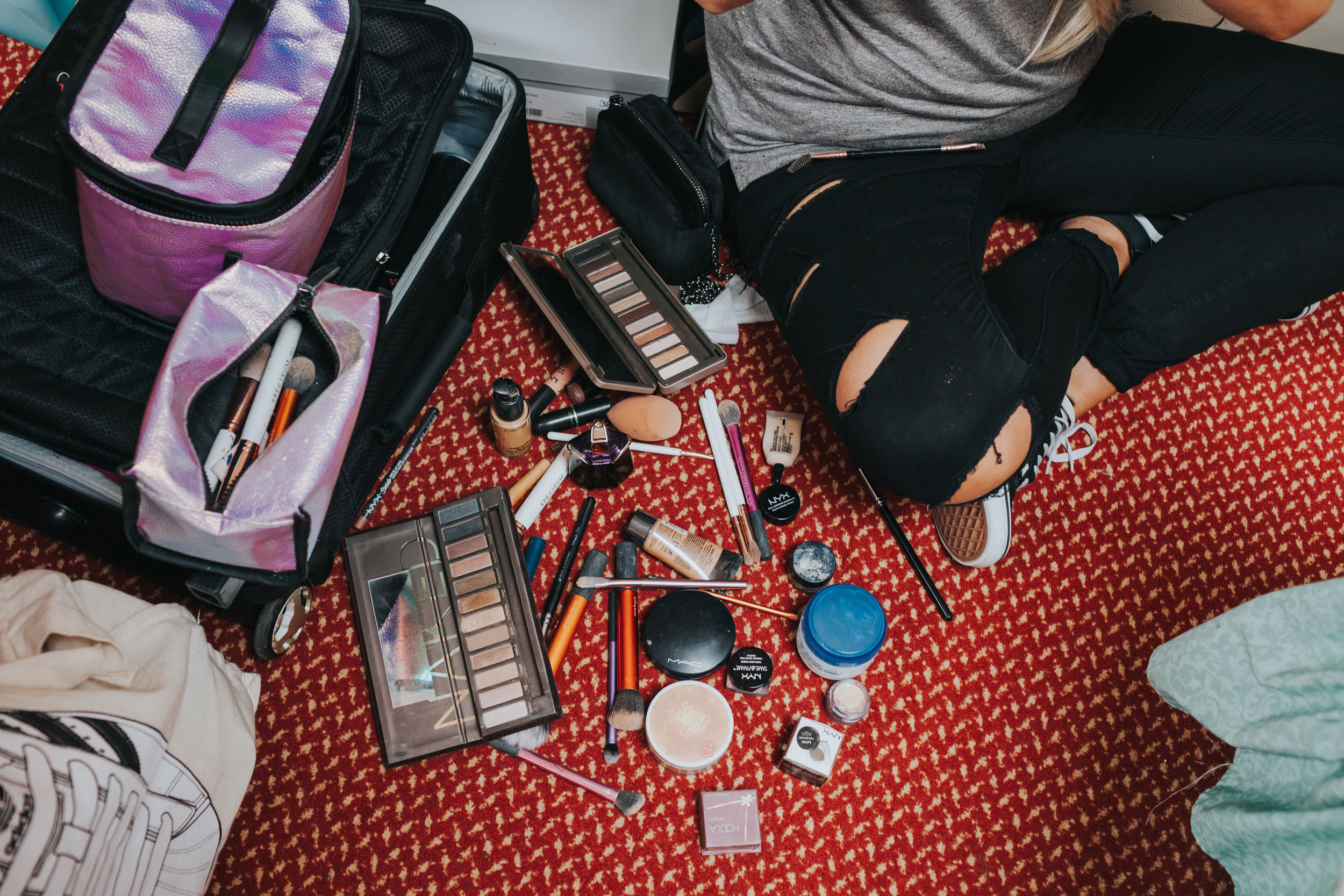 Make up scattered over the floor. 