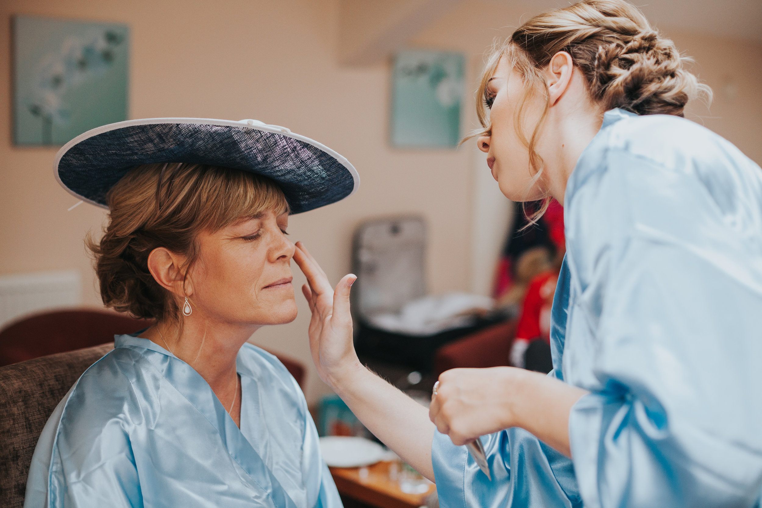 Mother of the bride has her make up done. 