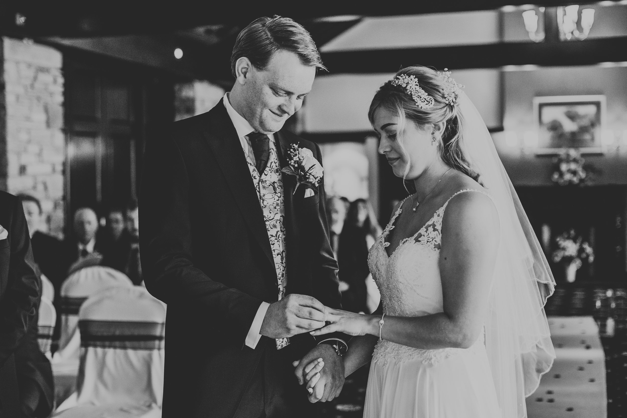 Bride and Groom put on their wedding rings.