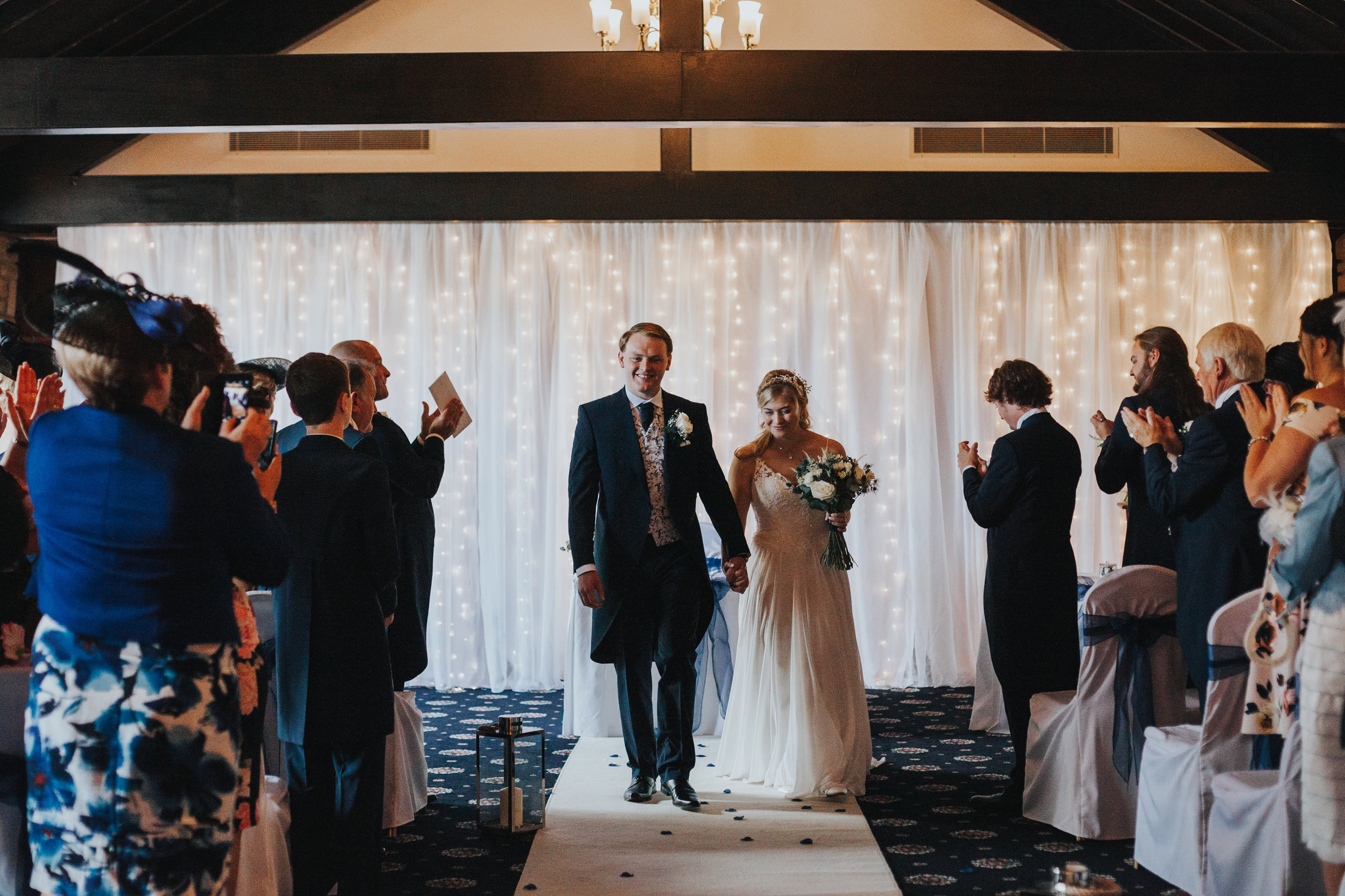 Bride and Groom walk back down the aisle at Mytton Fold as husband and wife. 