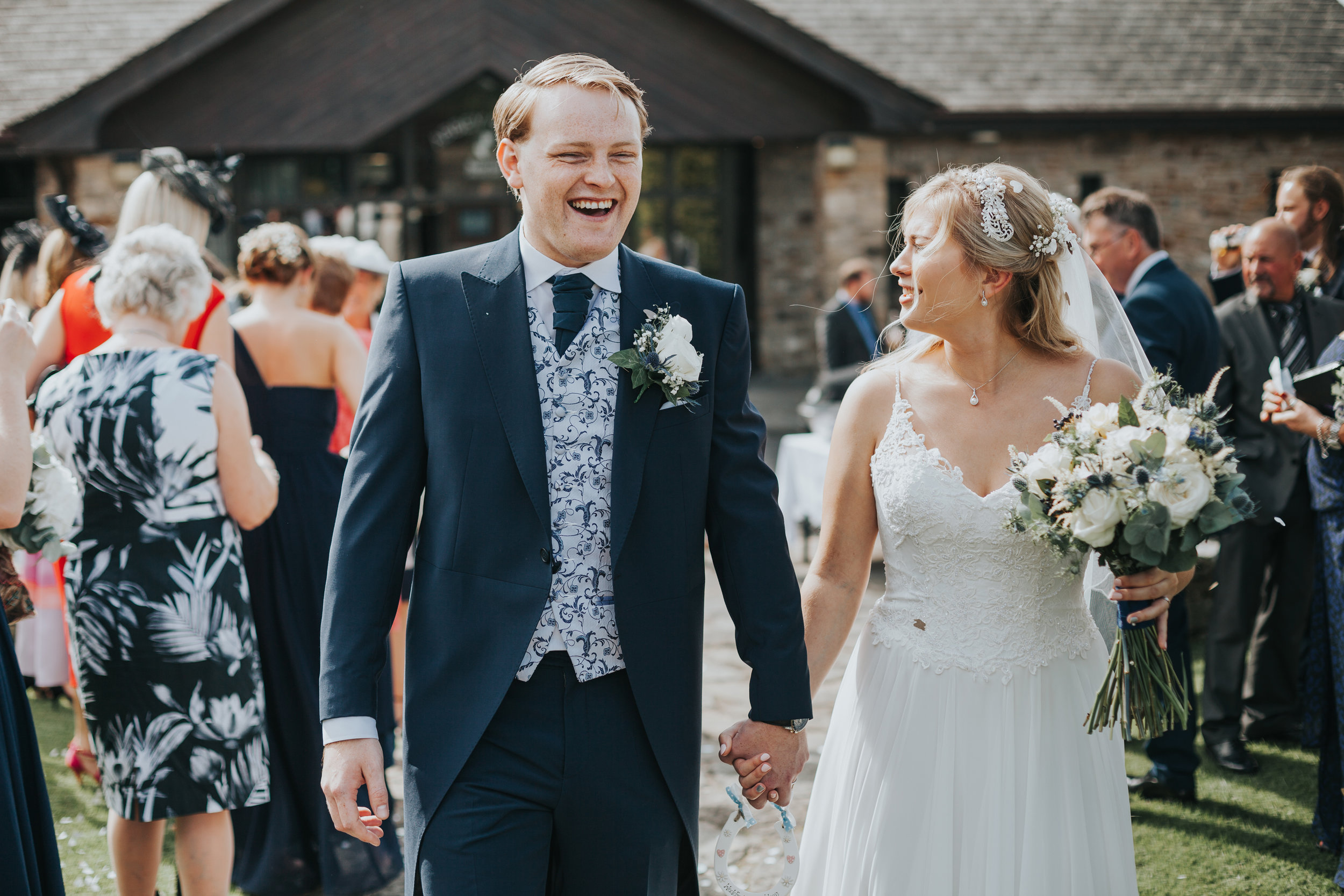 Bride and Groom laugh together. 