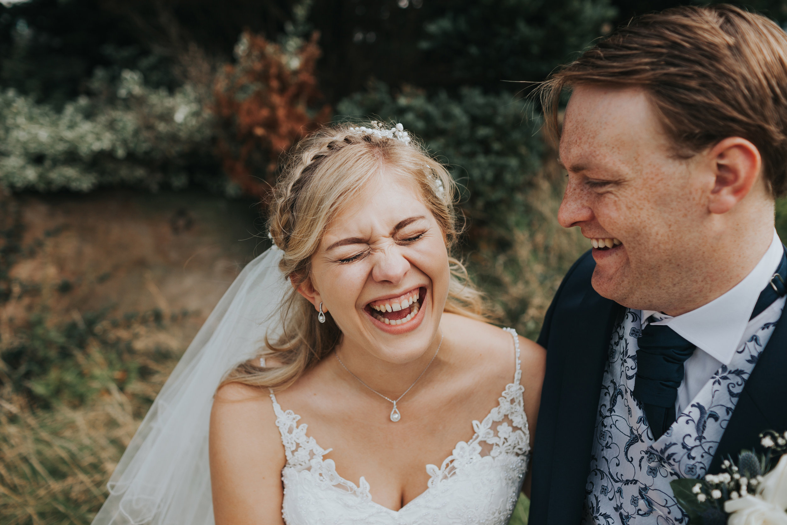 Bride cracks up laughing at Groom. 