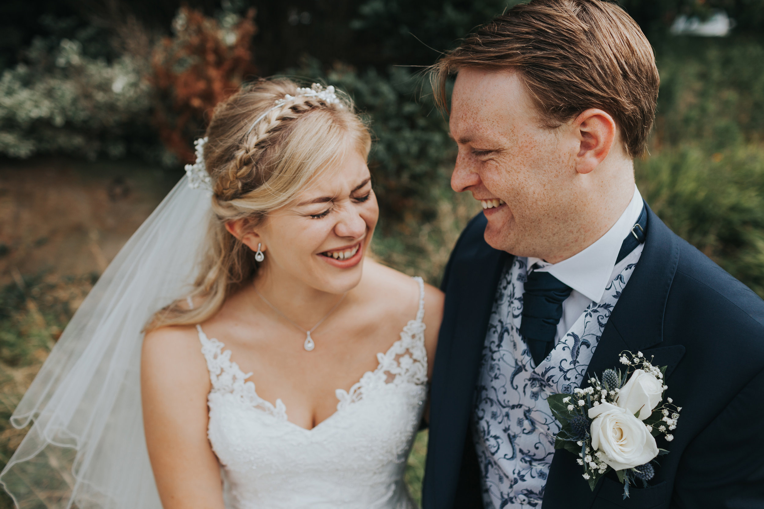 Bride and Groom sitting laughing together at Mytton Fold.