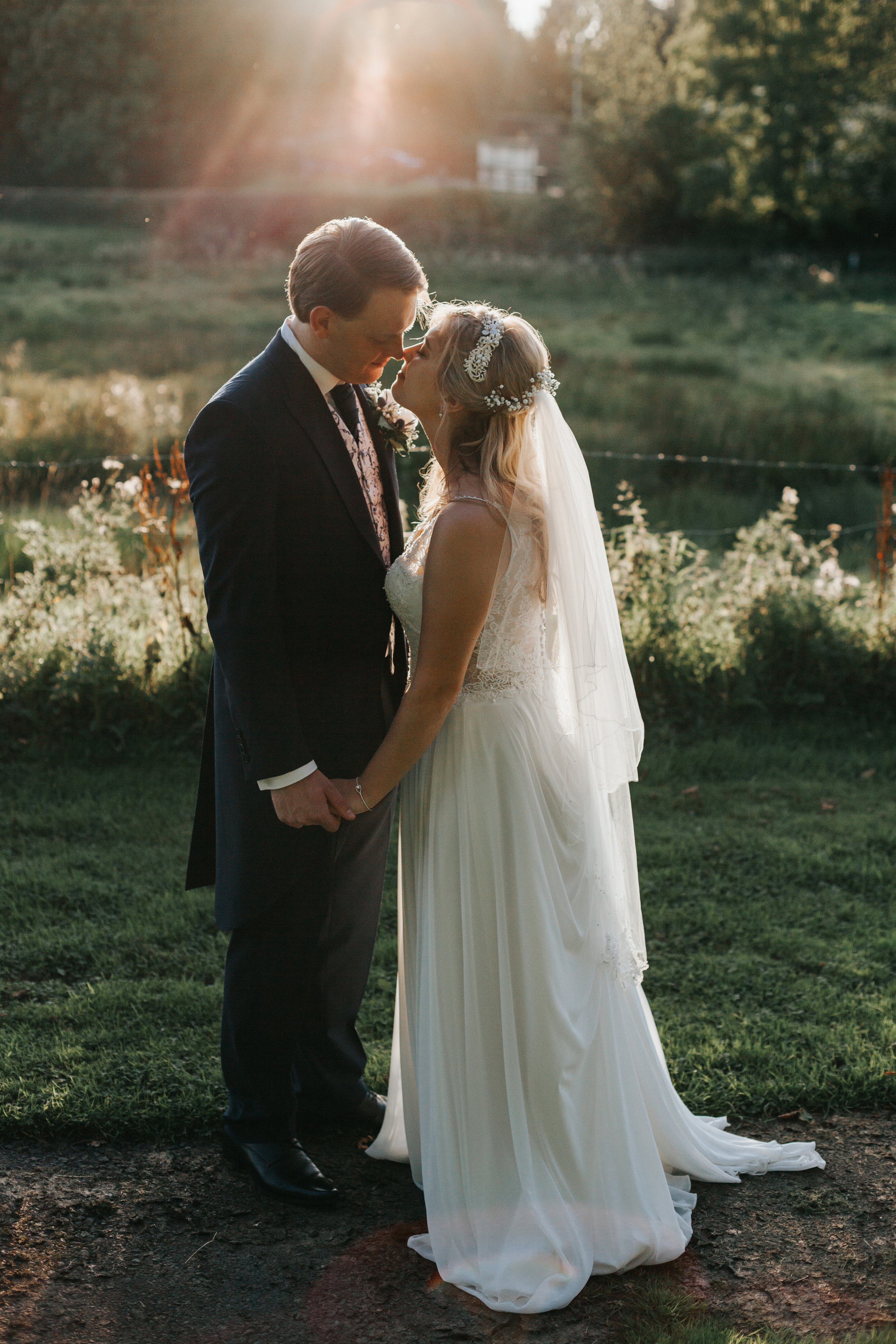 Bride and Groom share a kiss at sunset at Mytton Fold. 