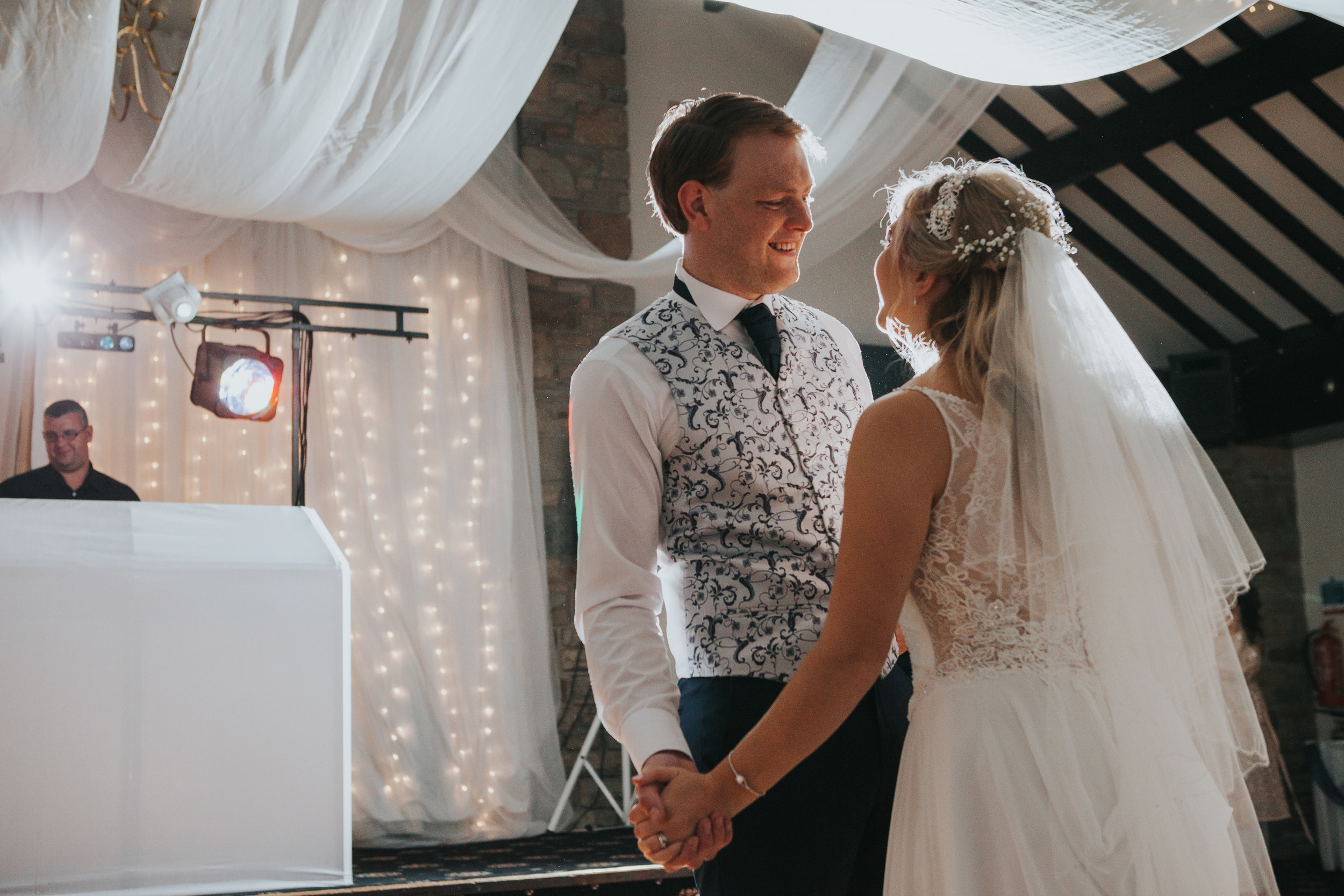 Groom smiles while Dancing with his Bride.