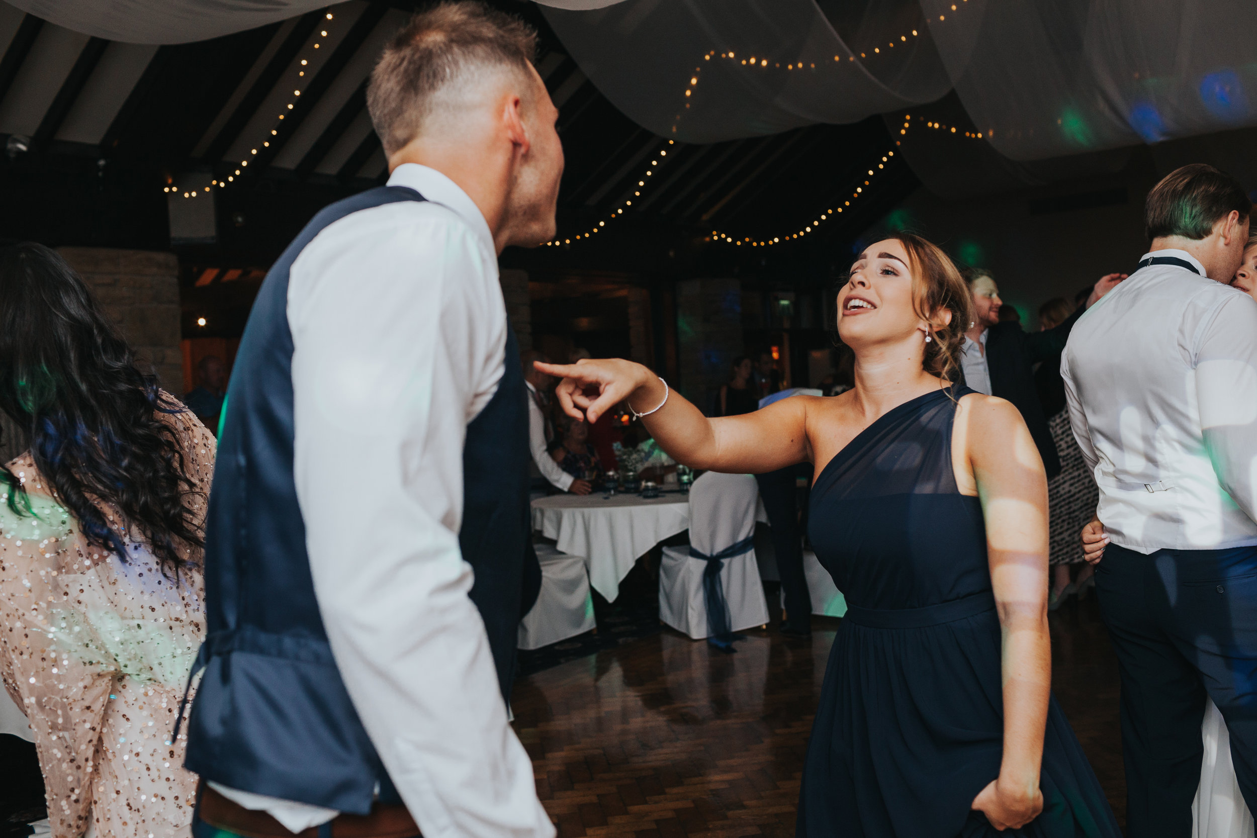 Bridesmaid dances with partner. 