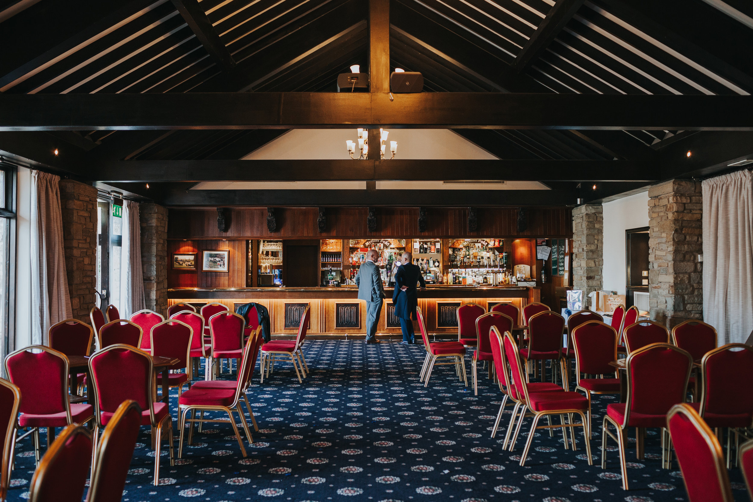 Father of the Bride and Father of the Groom share a drink at the bar at Mytton Fold Hotel. 