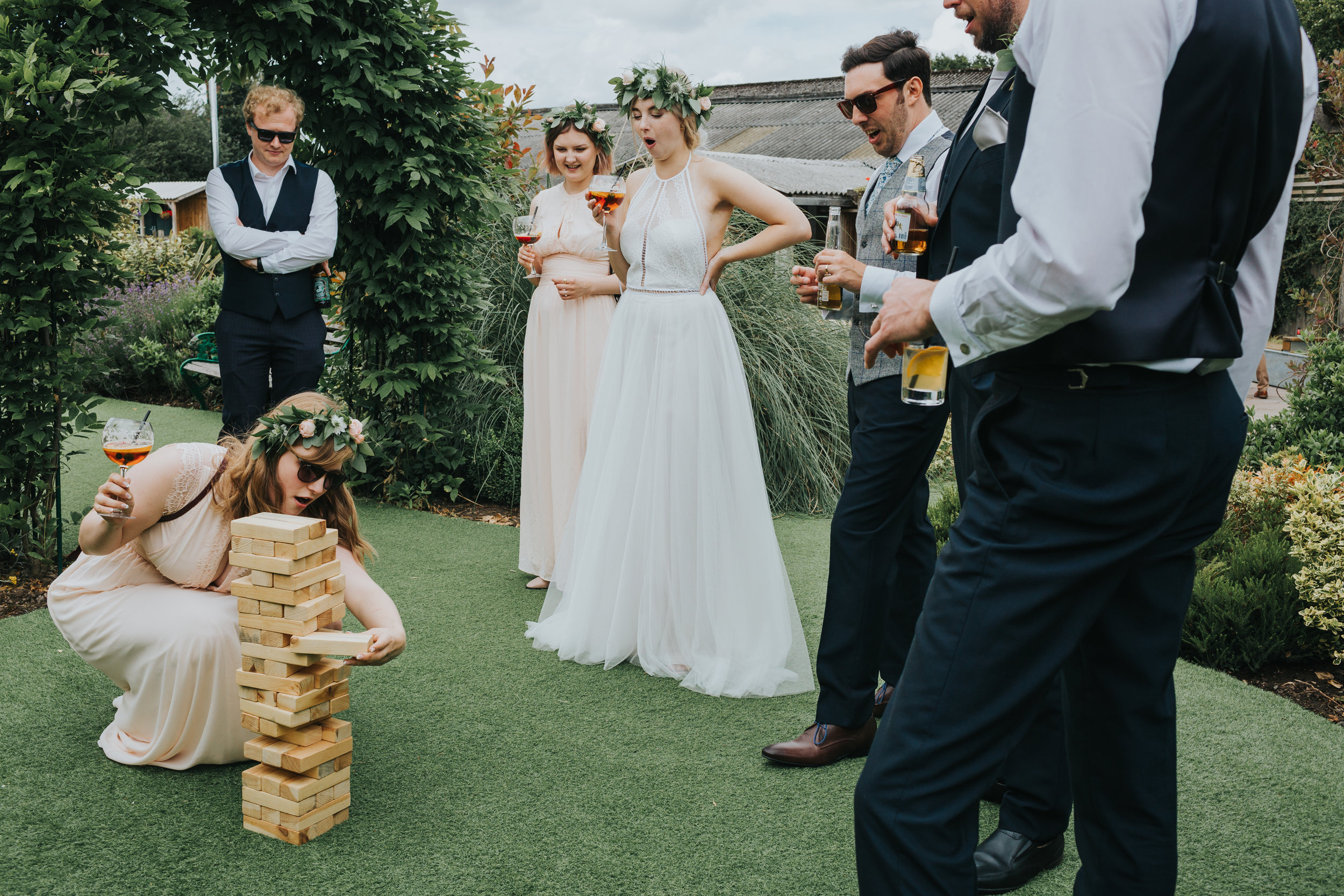 Bride, groom and bridal party watch on as bridesmaid pulls a rouge Jenga move! 