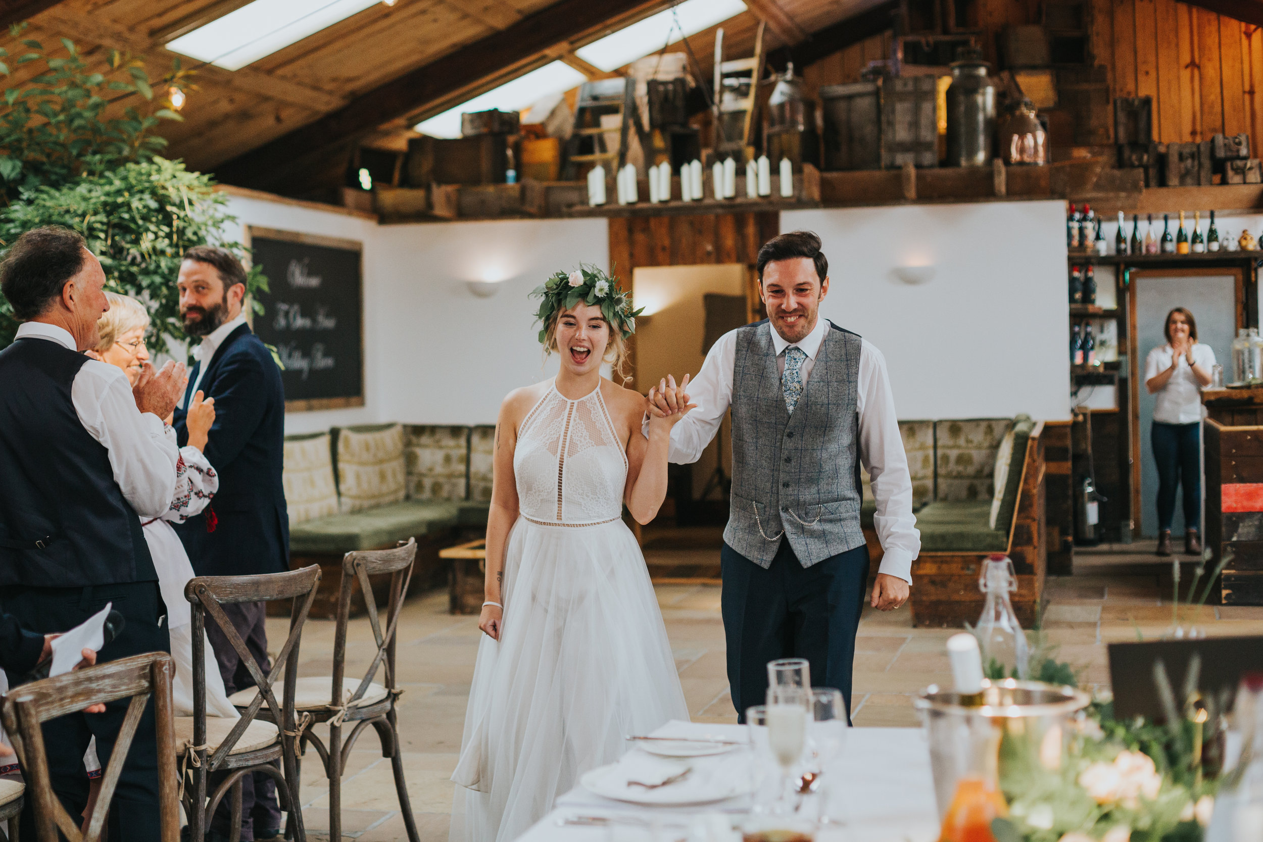 Bride and groom enter their wedding breakfast. 