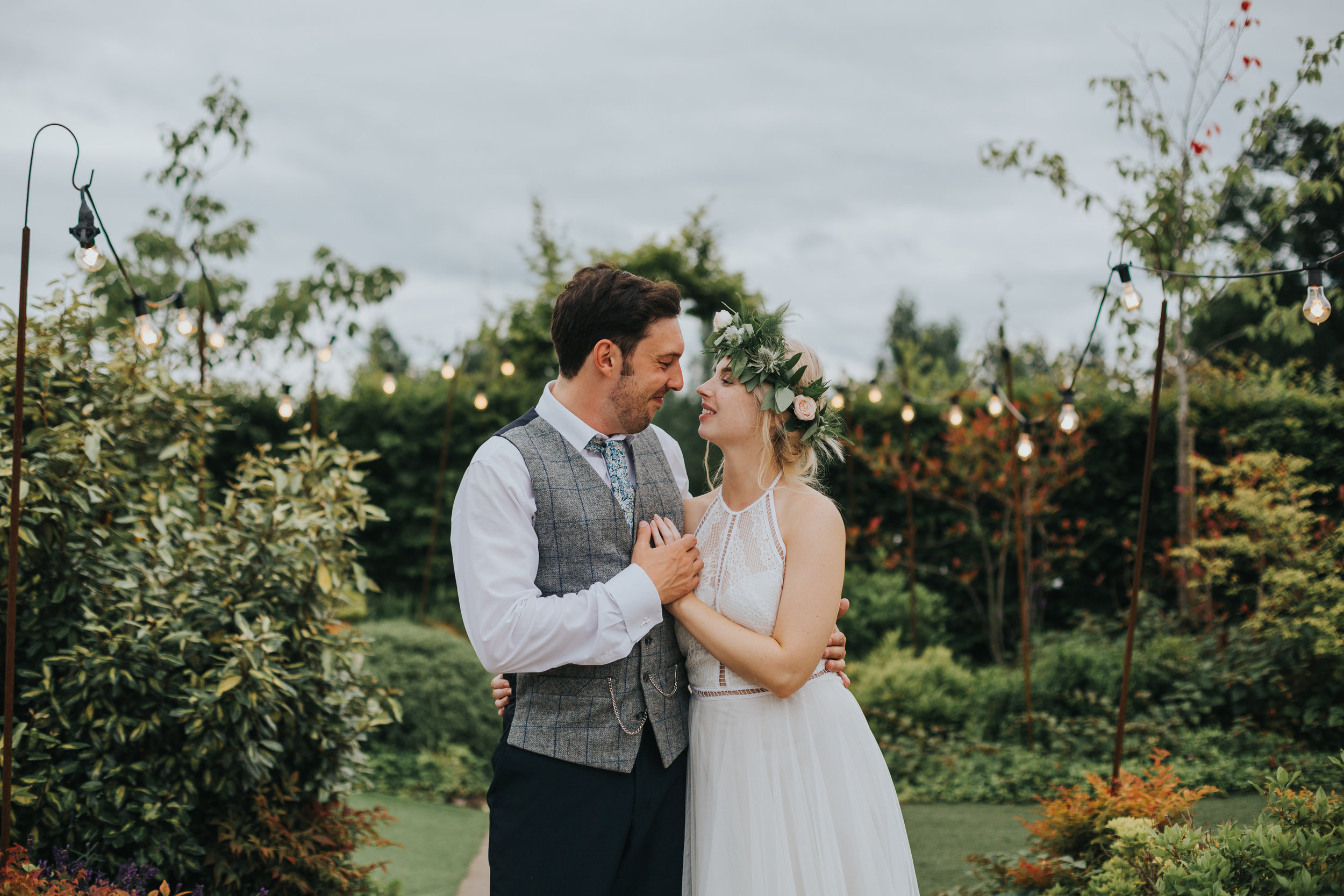 Bride and Groom have a photo in front of the archway. 