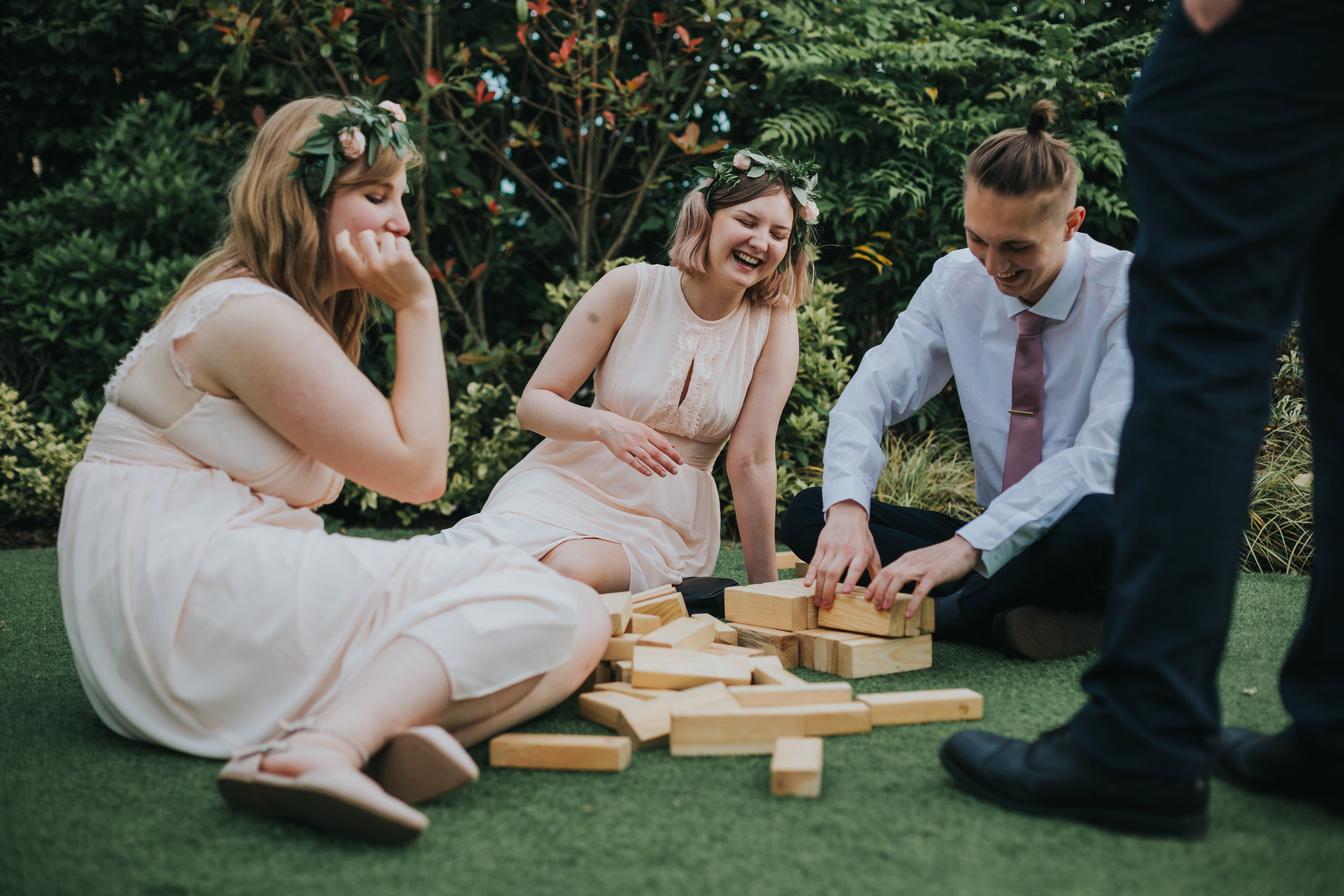 Bridesmaids laughing and playing Jenga. 