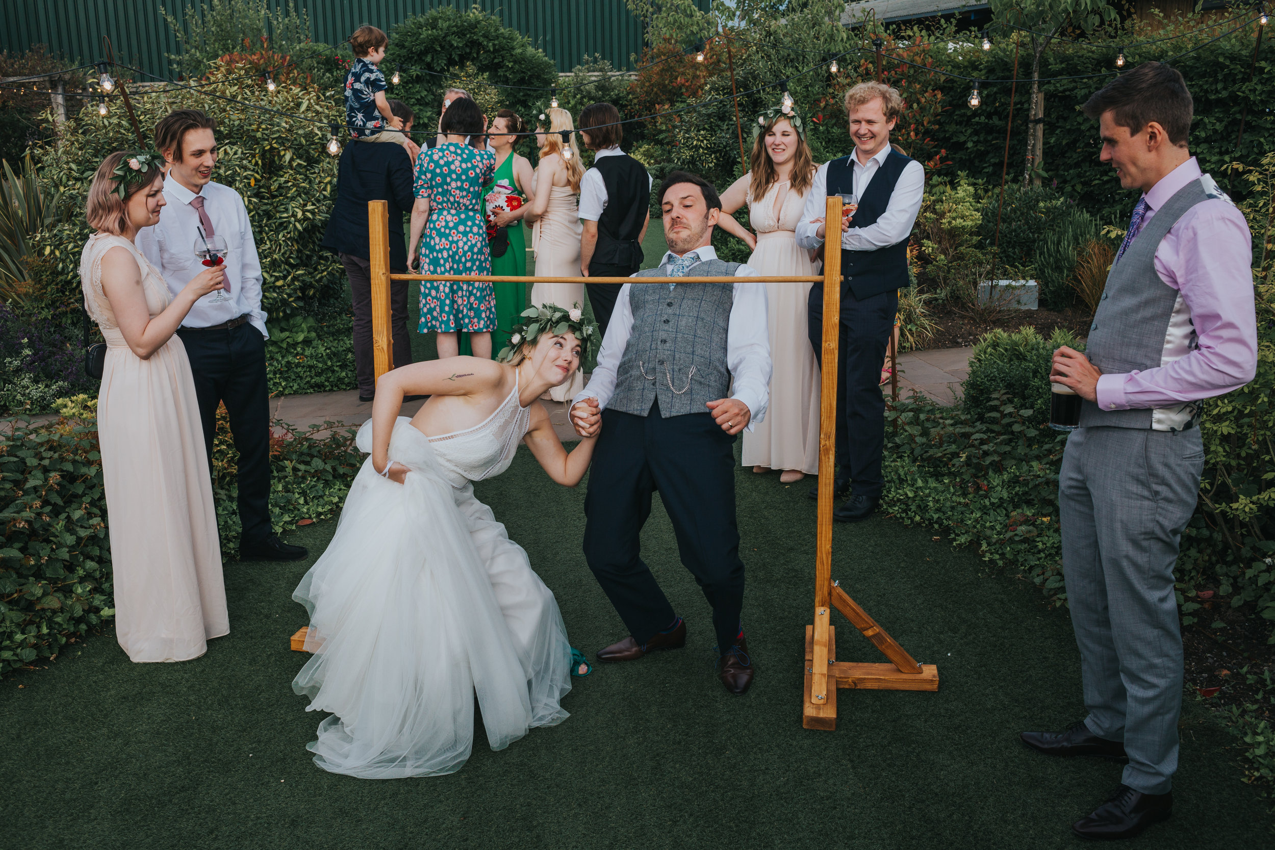 Bride and groom try and limbo together. It doesn't really work. 