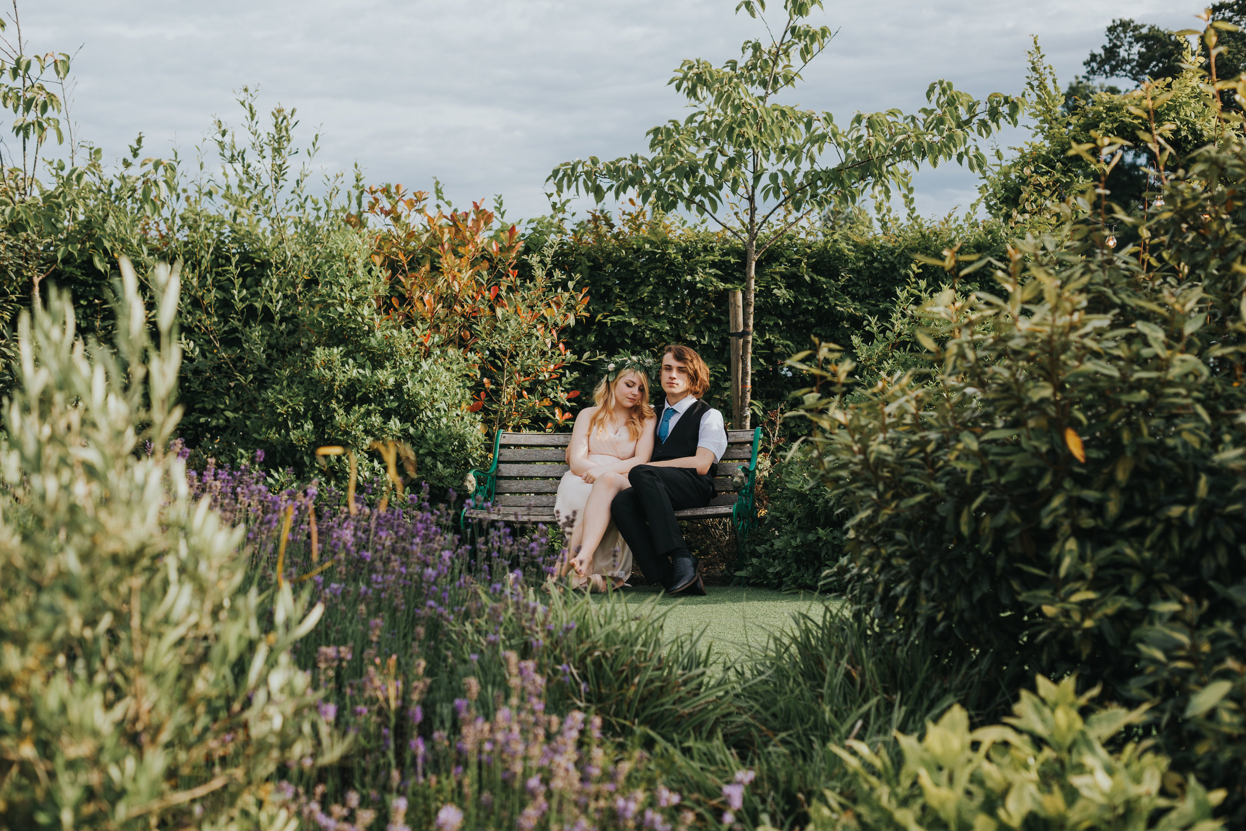 Bridesmaid and her boyfriend sneak off for a quiet moment. 