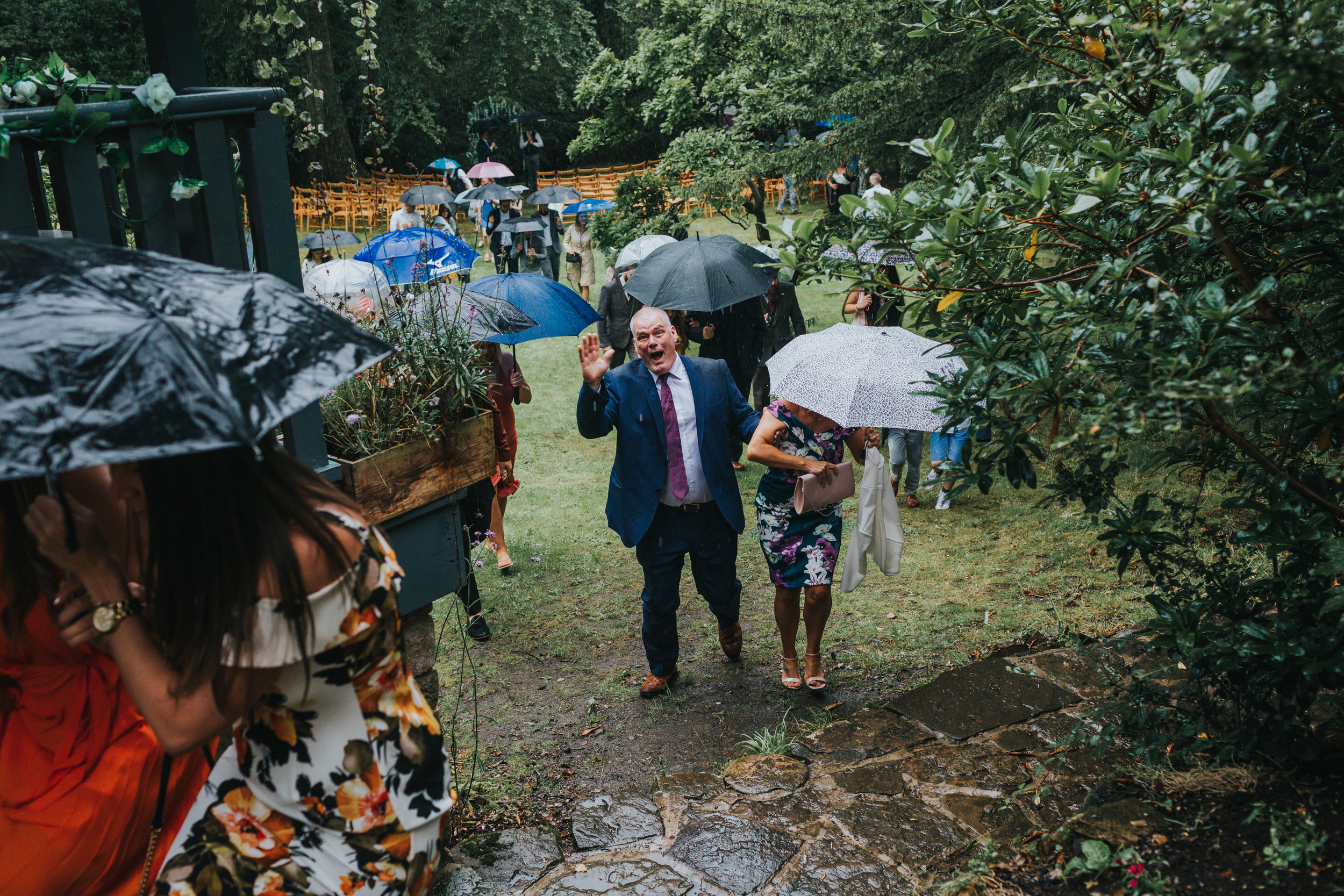 Weddings guests make their way back indoors as the rain becomes to heavy. 