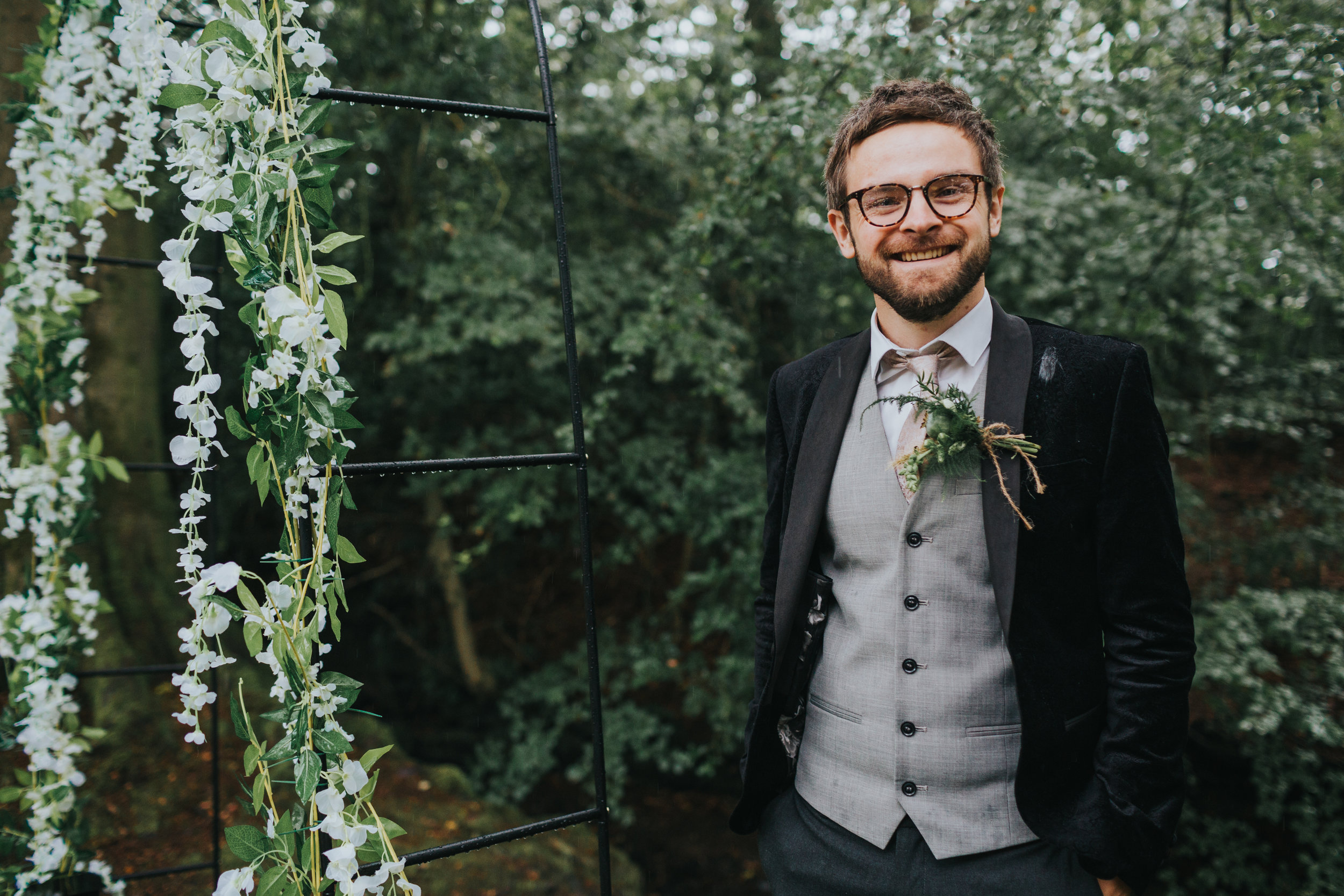 The Groom waits for his bride in the rain at Spring Cottage Rivington. 