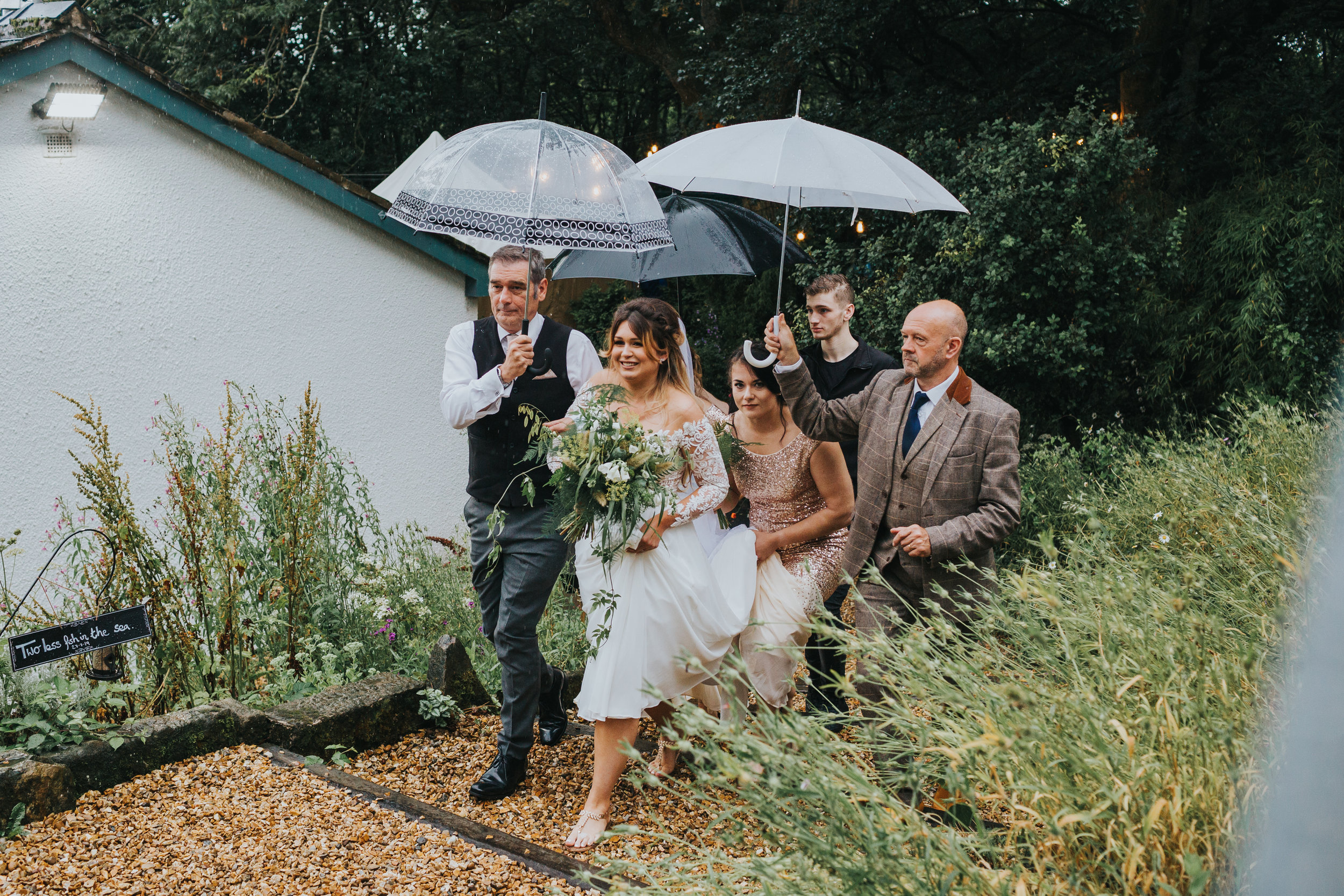 The bride is walked up the steps to the marque by her father.