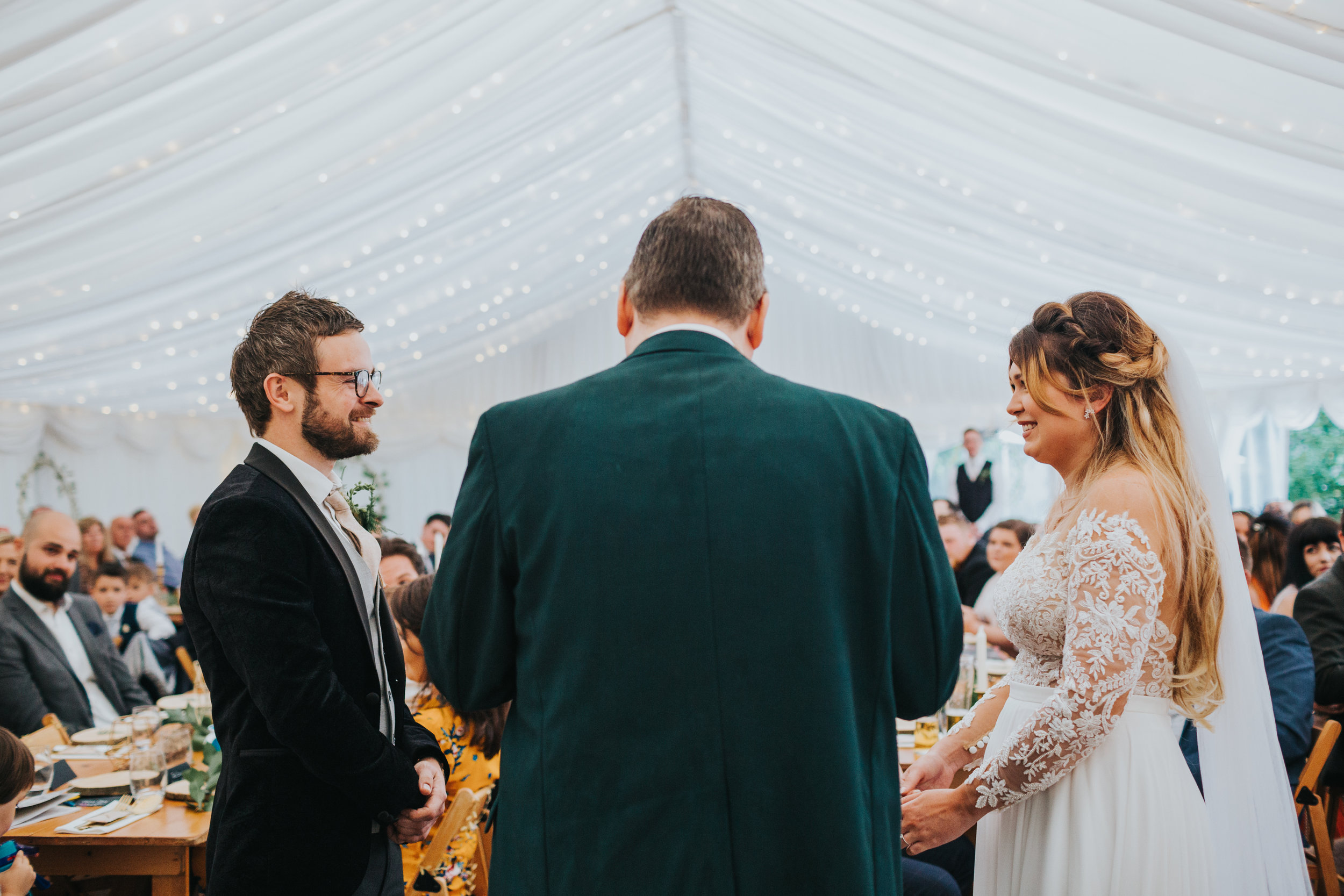 Bride and groom face one another.