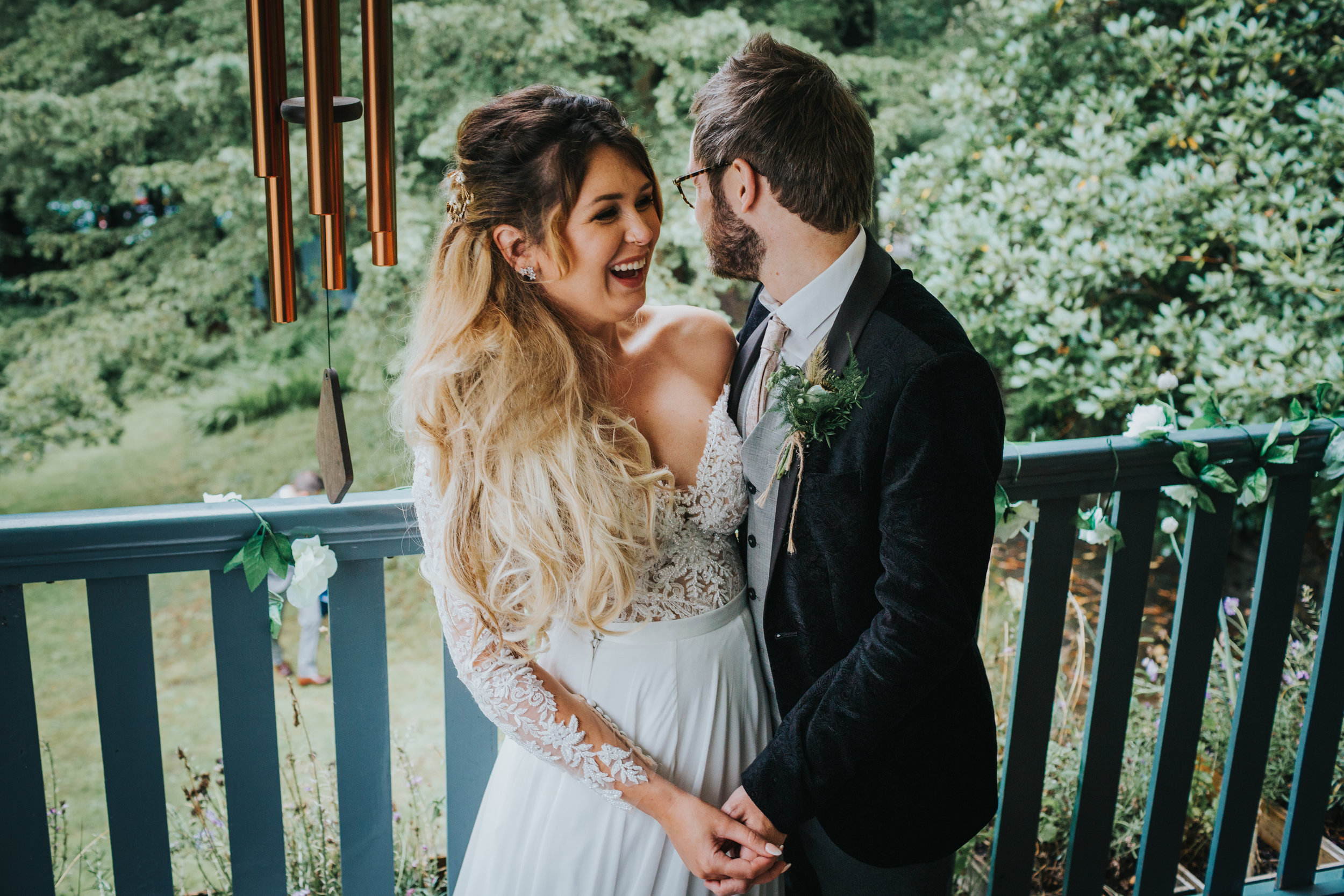 Bride and groom take some time out on balcony together. 