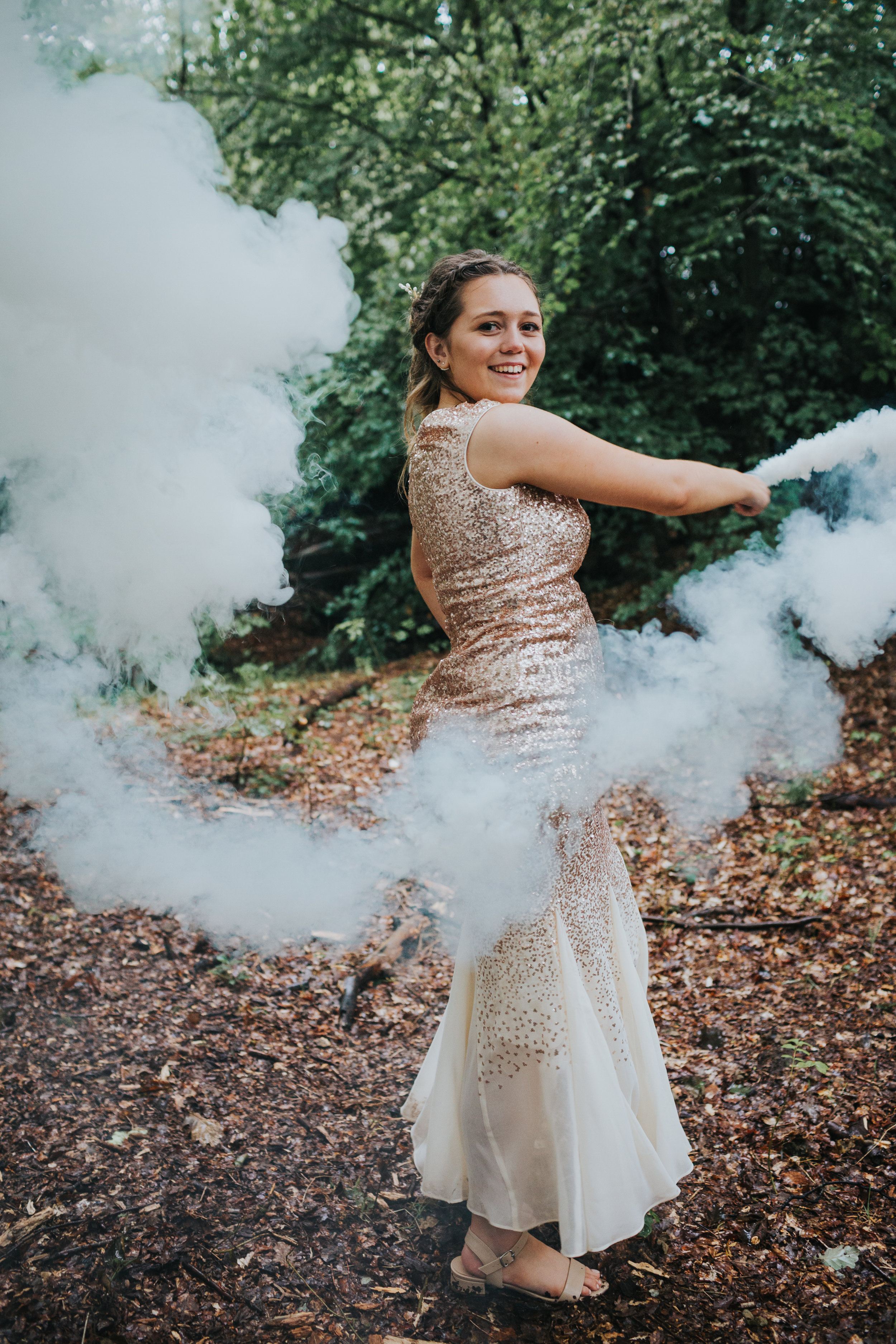 Bridesmaid swirls smoke bomb around. 