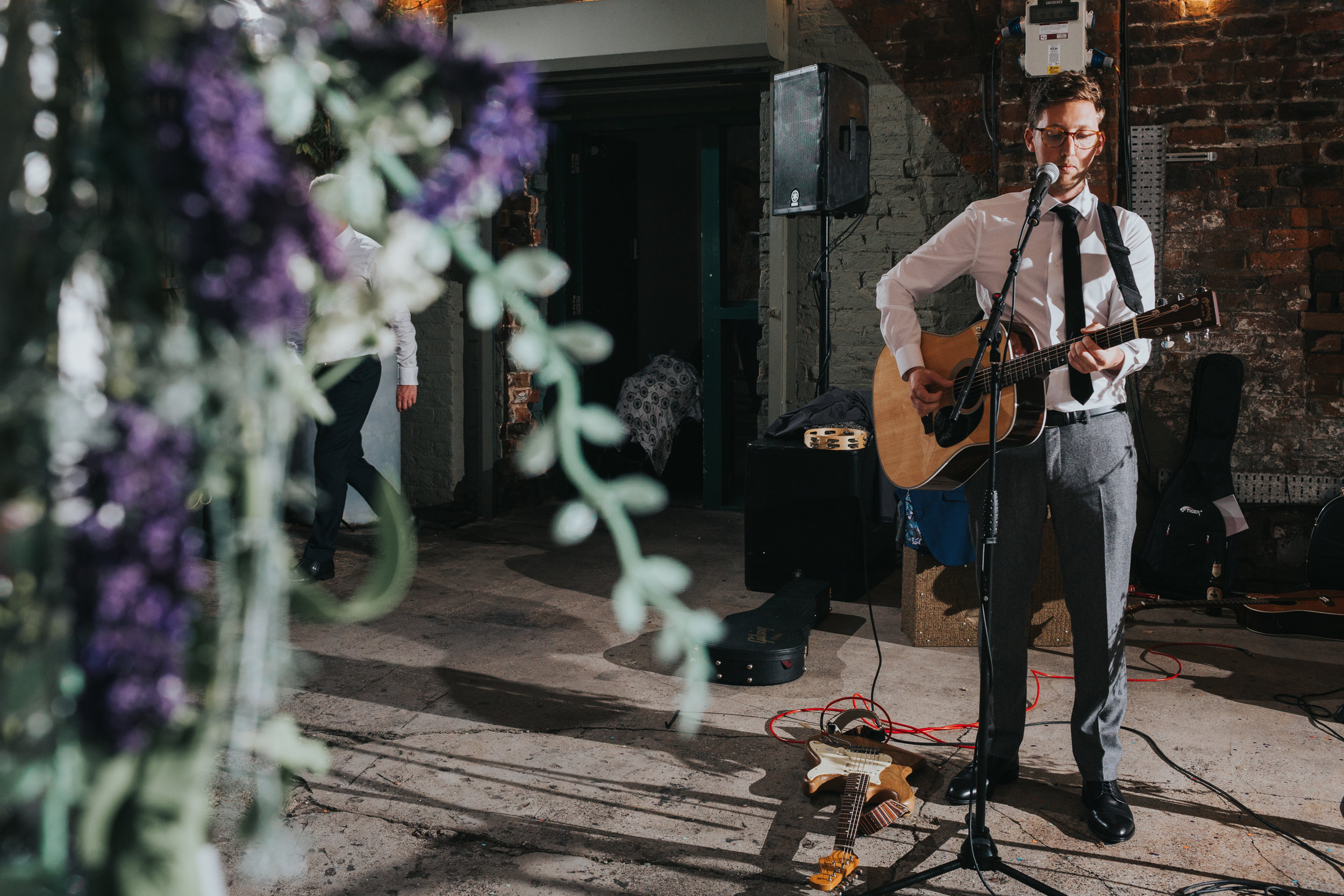 The Groom takes the stage to perform a song.