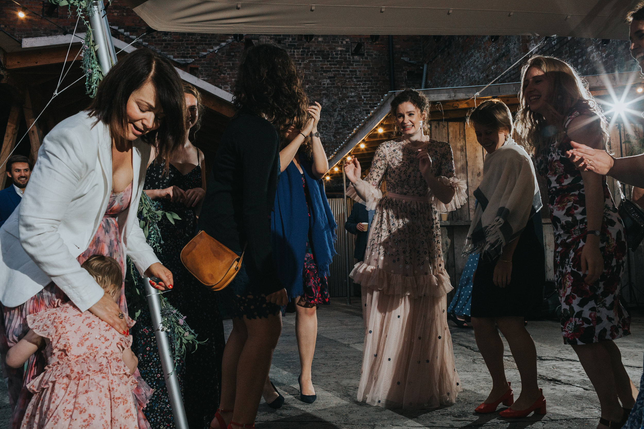 Bride dances with her friends and family as the band plays. 