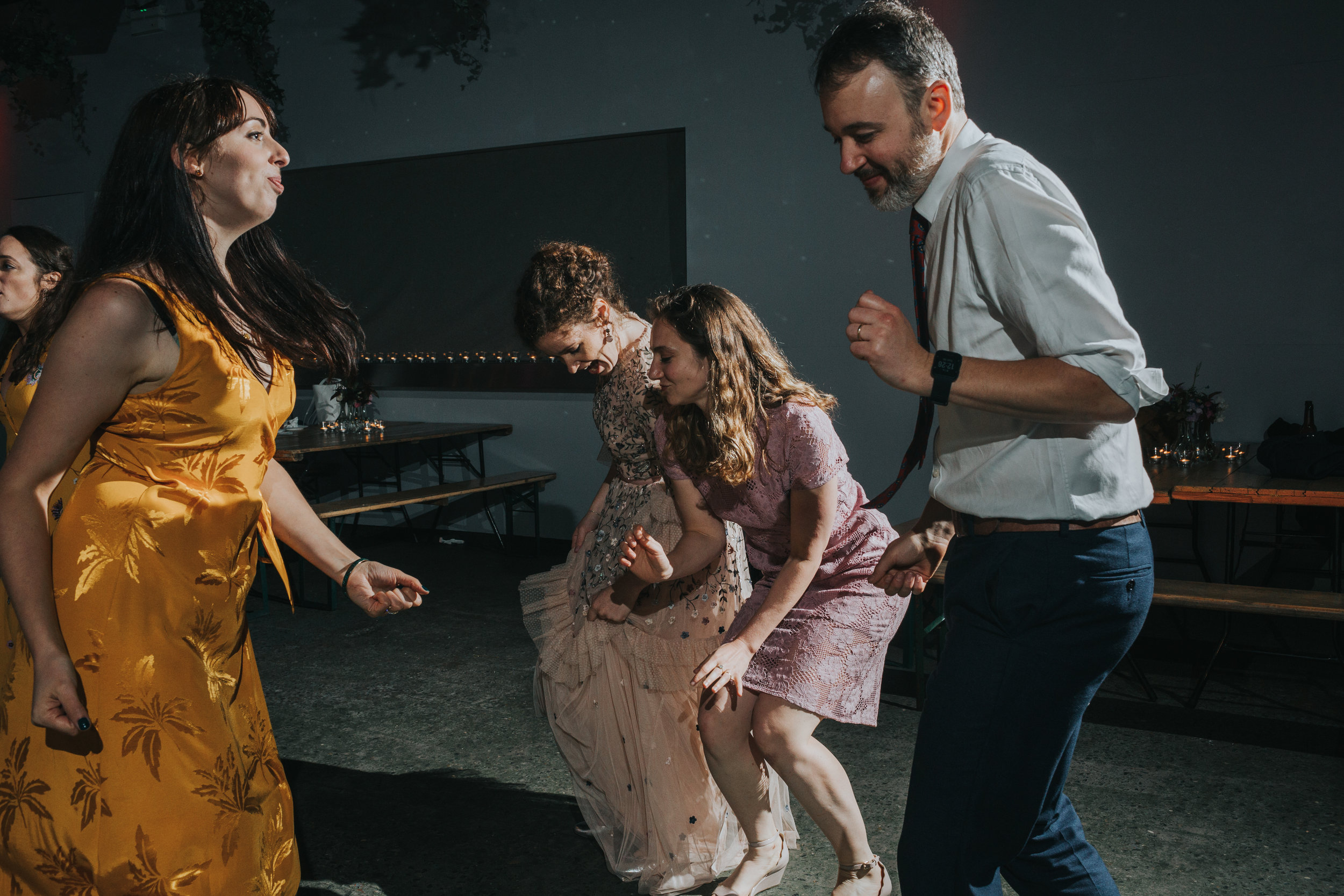 Bride throws some shapes on the dance floor with her mates. 