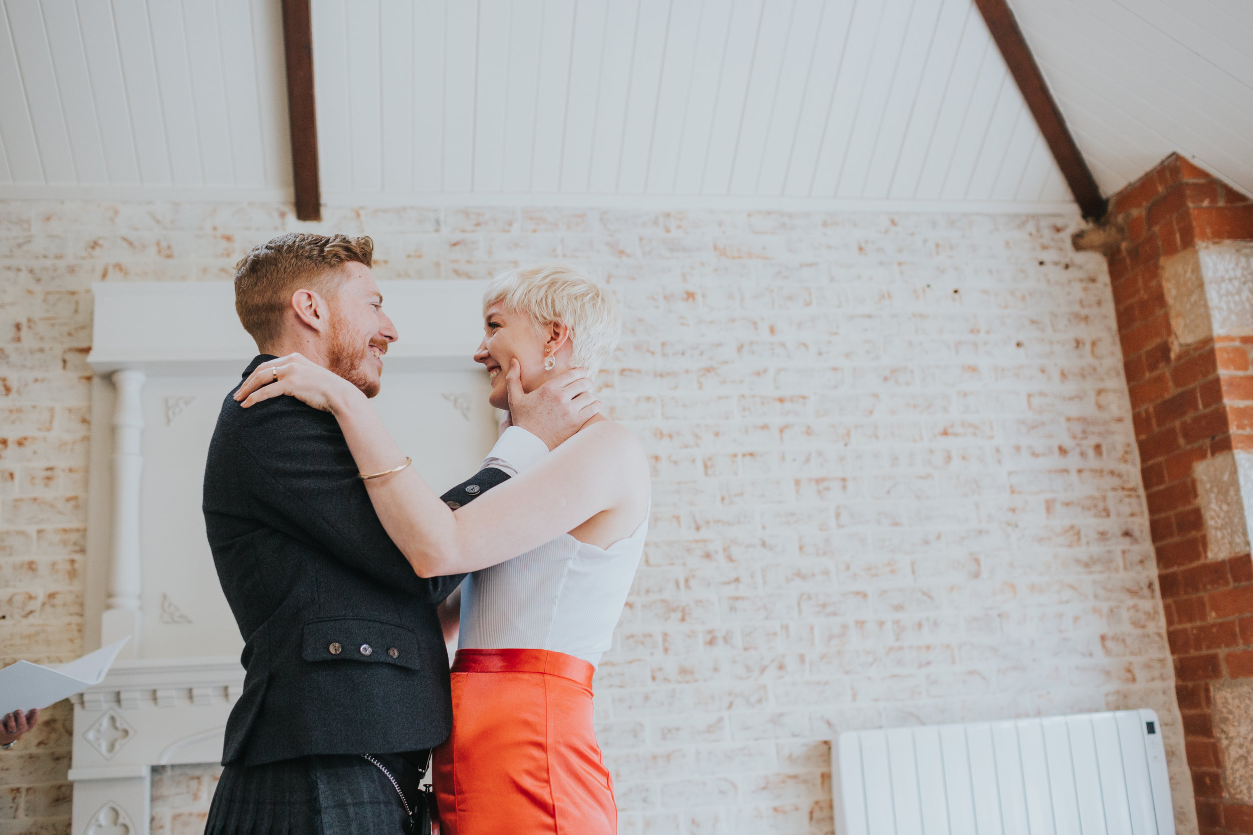 Bride and groom hold each other for a moment in front of their friends  and family. 