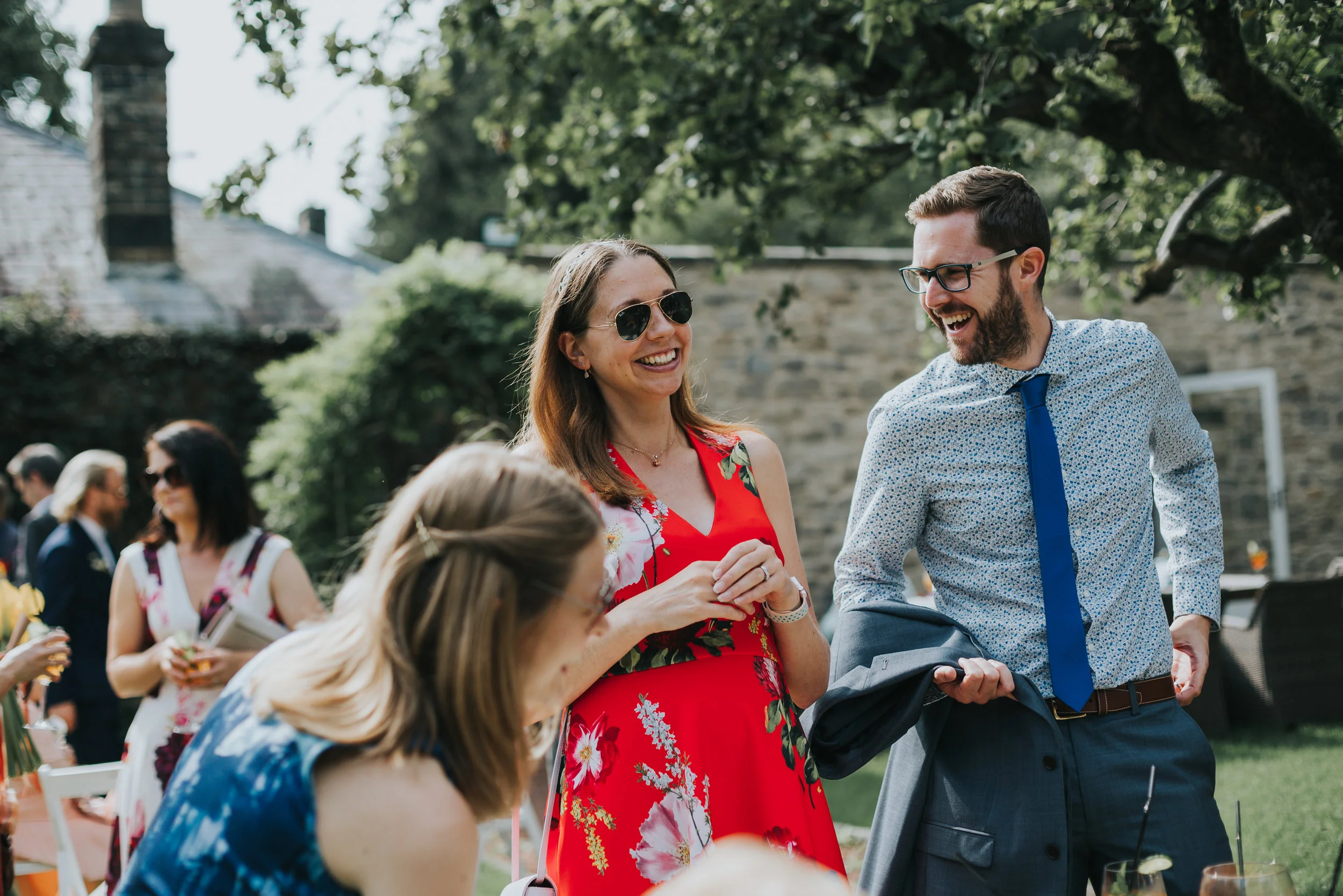 Guests enjoy a laugh under a tree in Shotton Granges Walled garden.