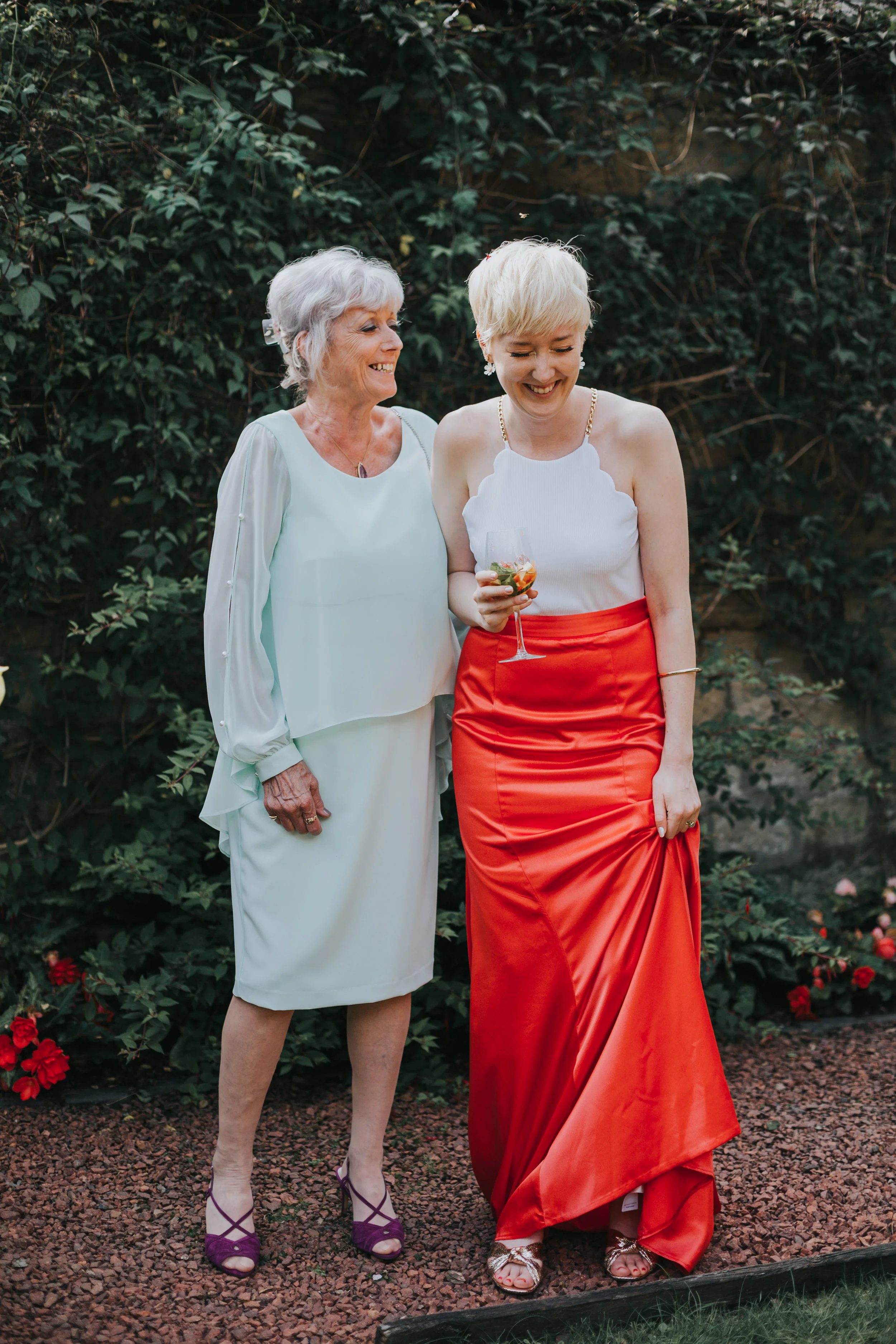 The bride and her mother enjoy a laugh together.