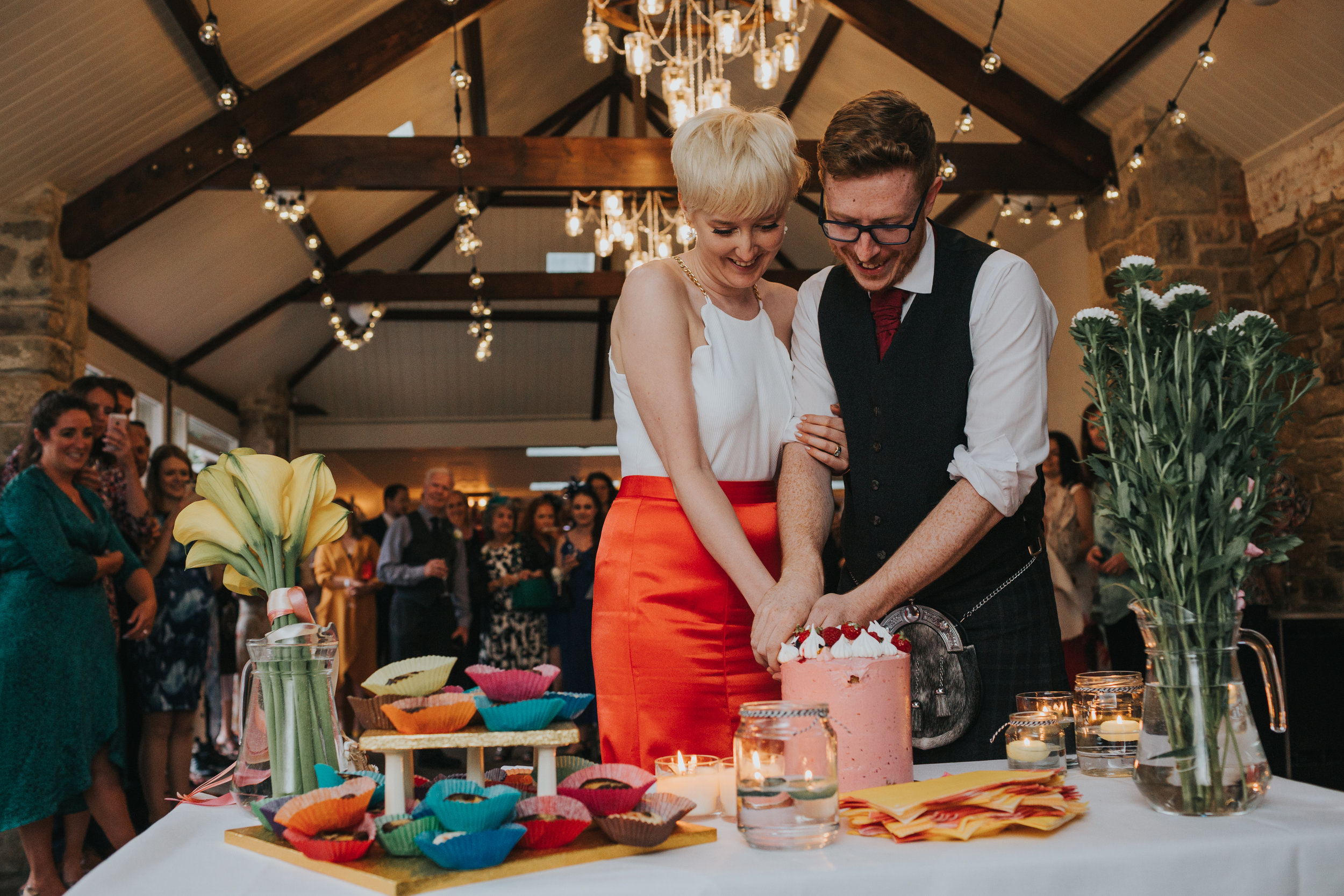 Bride and groom cut cake. 