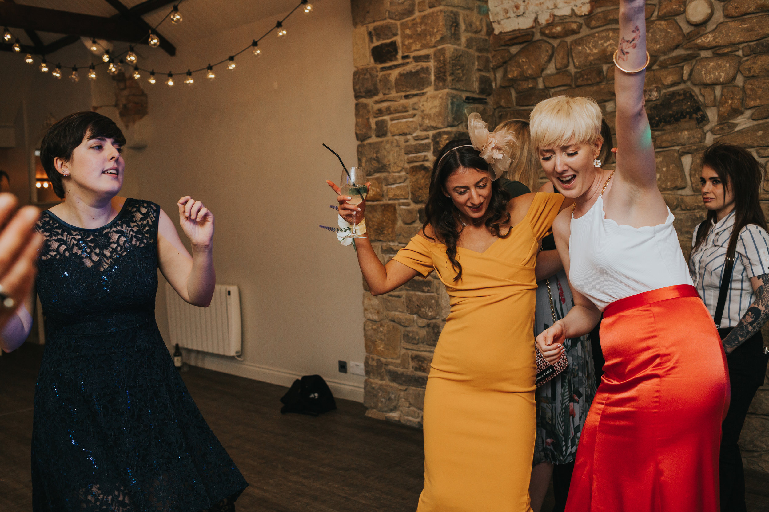 The bride dances with her friends. 