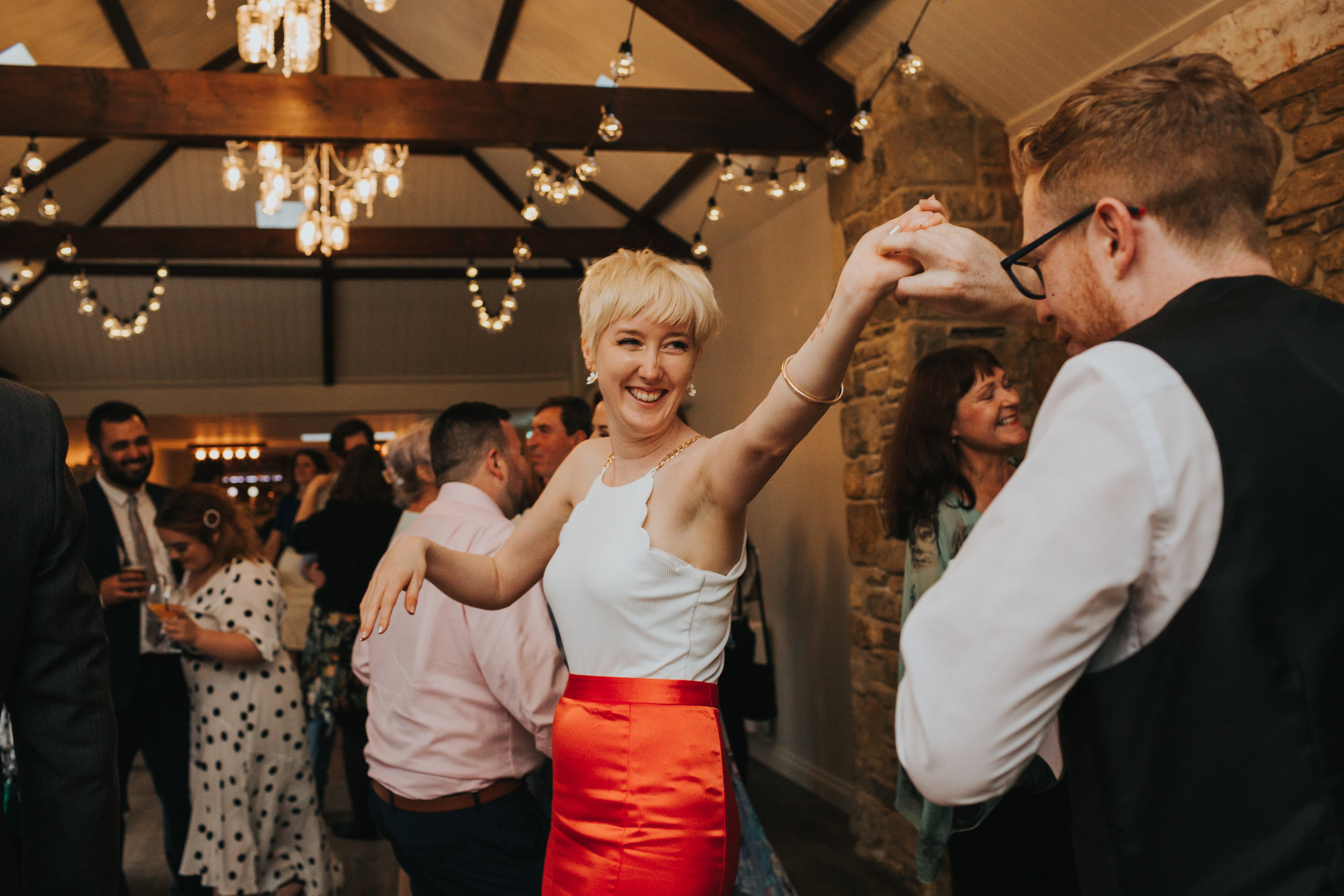 Bride and groom mess around on the dance floor. 