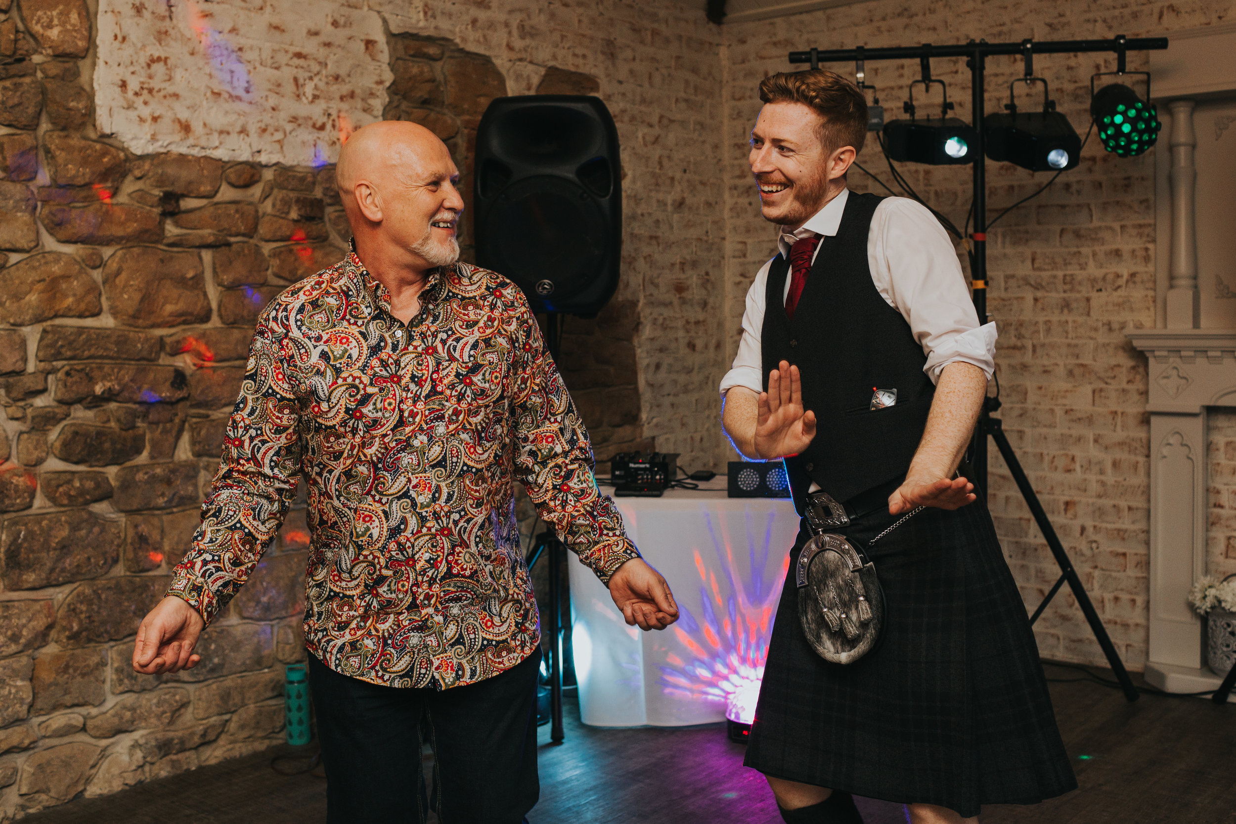 The groom has a cheeky dance with his mates. 