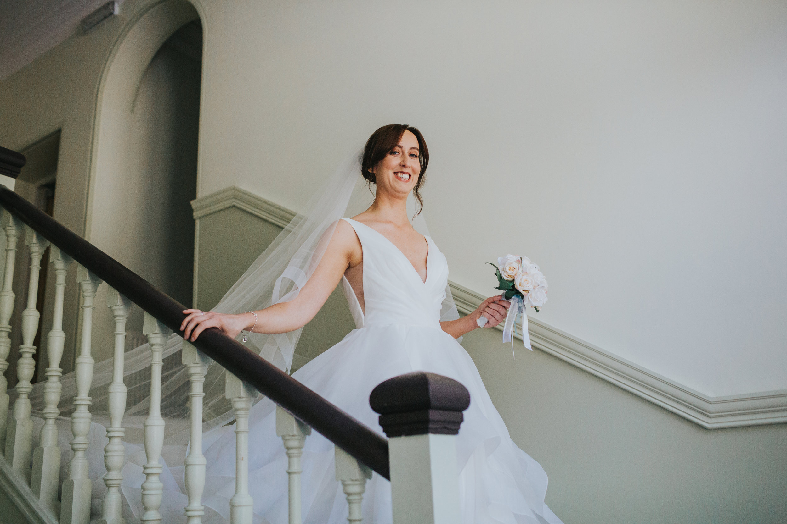 Bride makes her way down the stairs. 