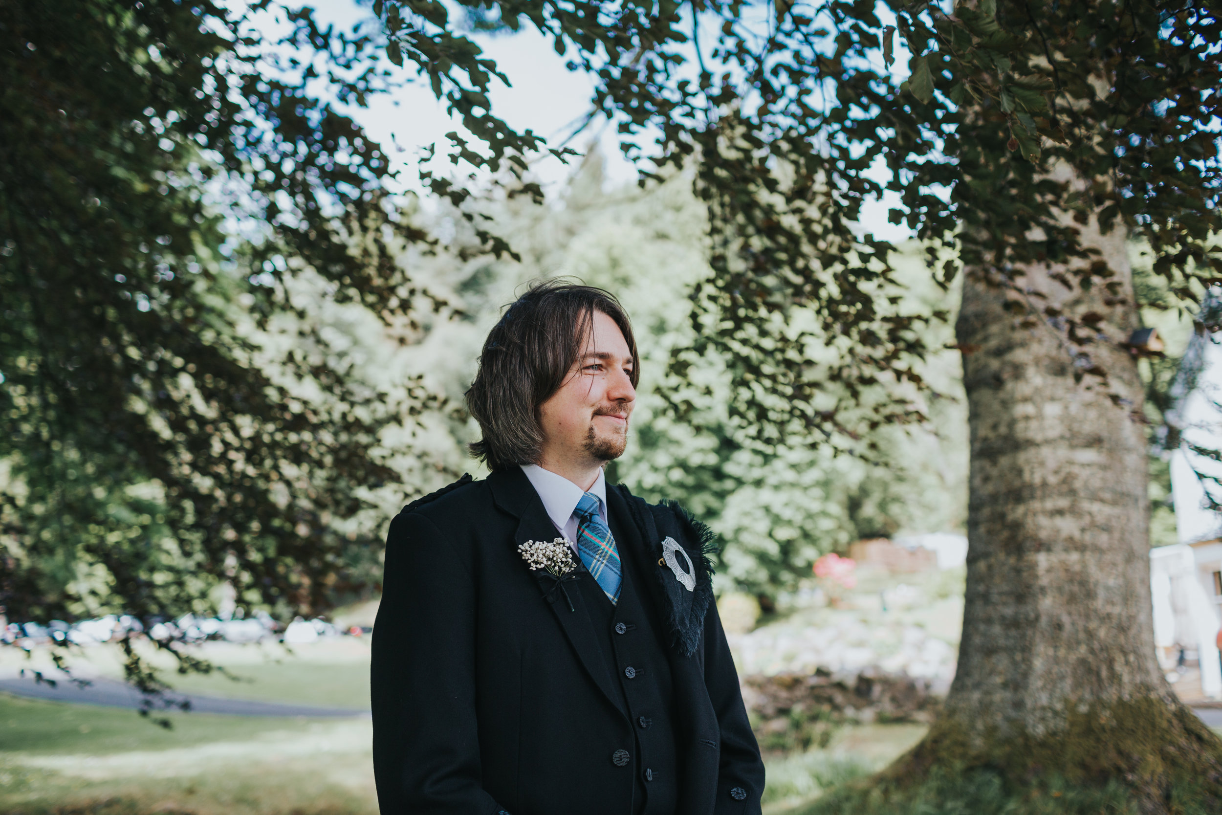 Groom smiles as he watches his bride come down the aisle. 