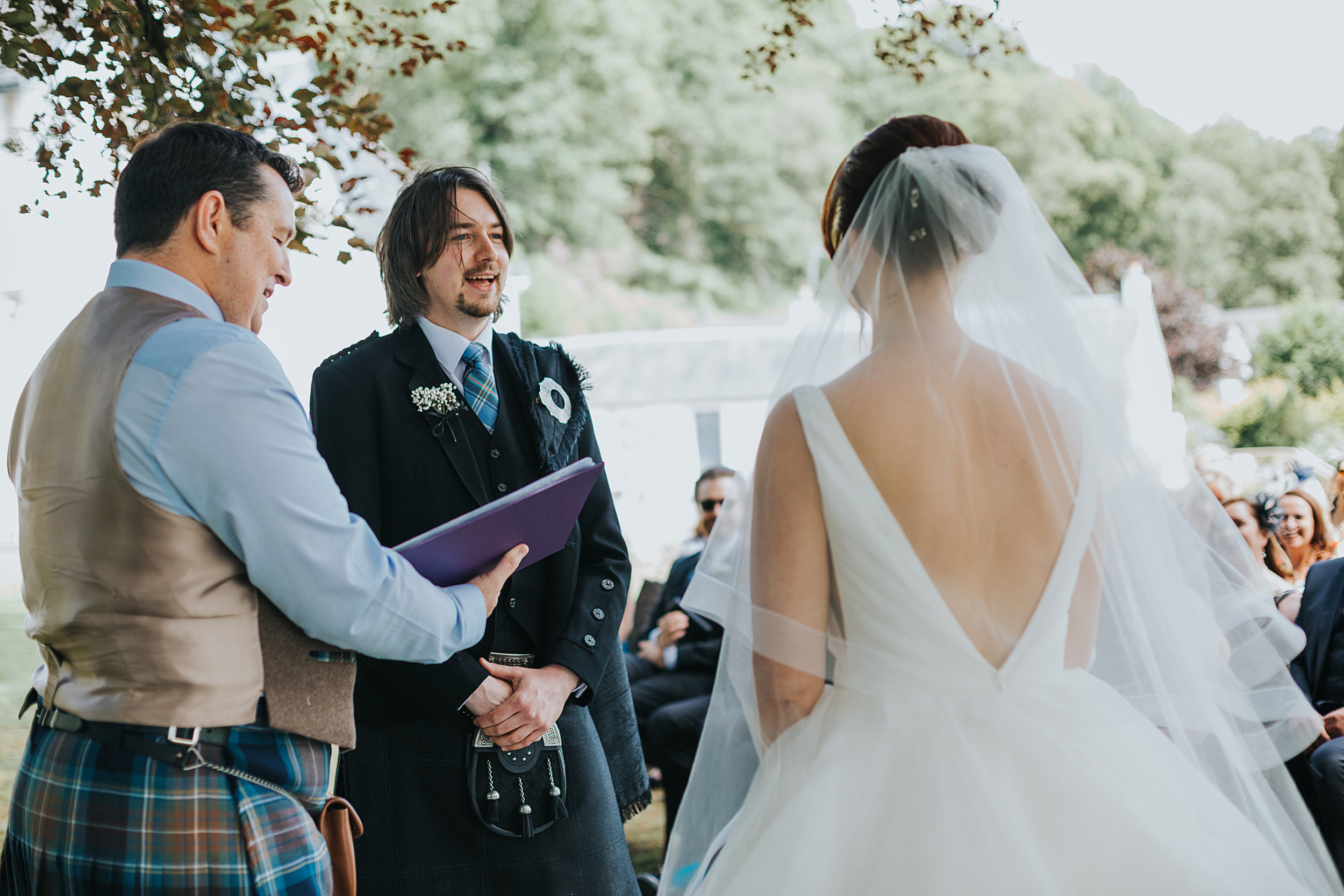 Groom smiles at his bride.